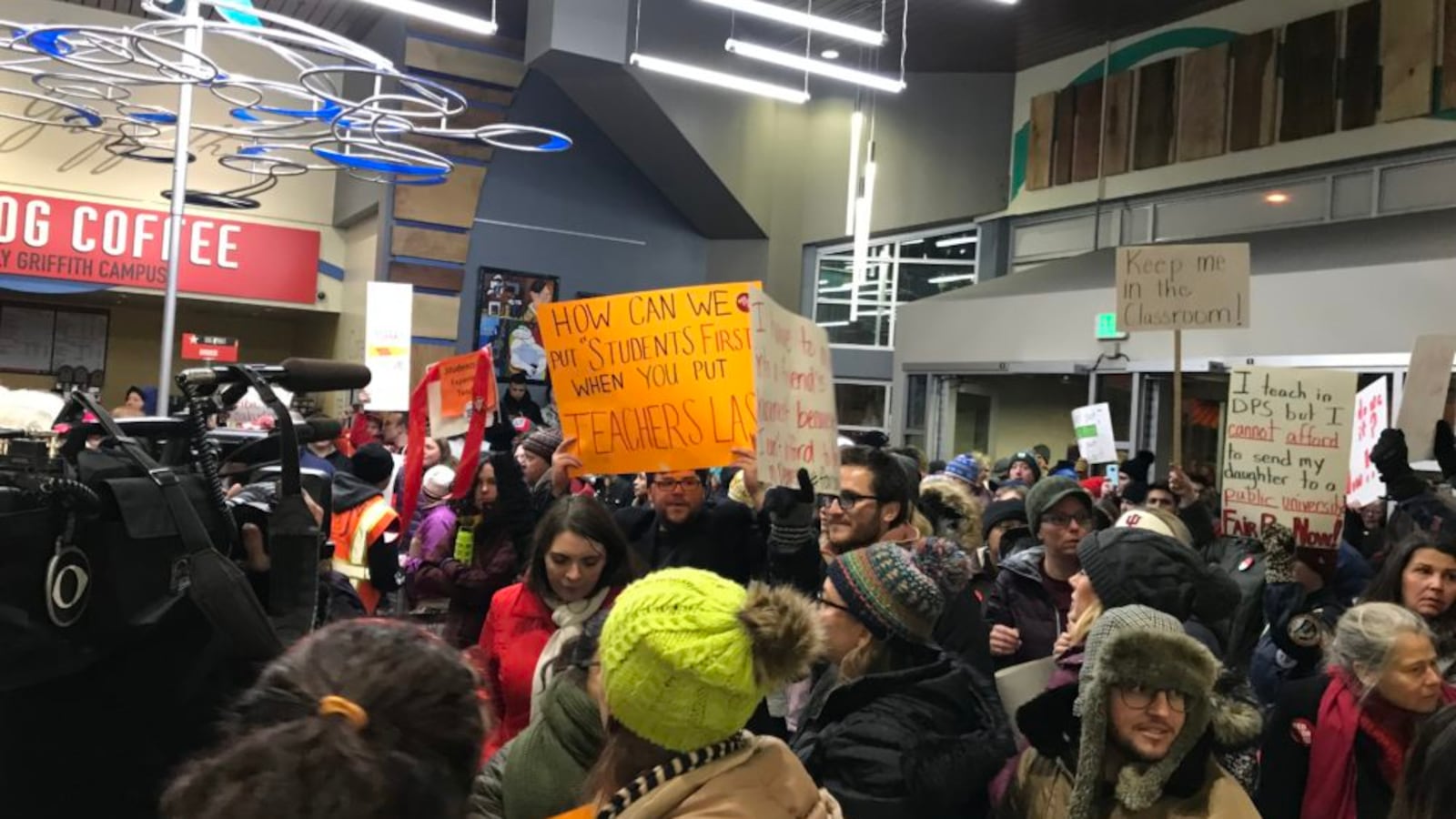 Denver teachers pack the lobby of the district headquarters to demand fair pay.