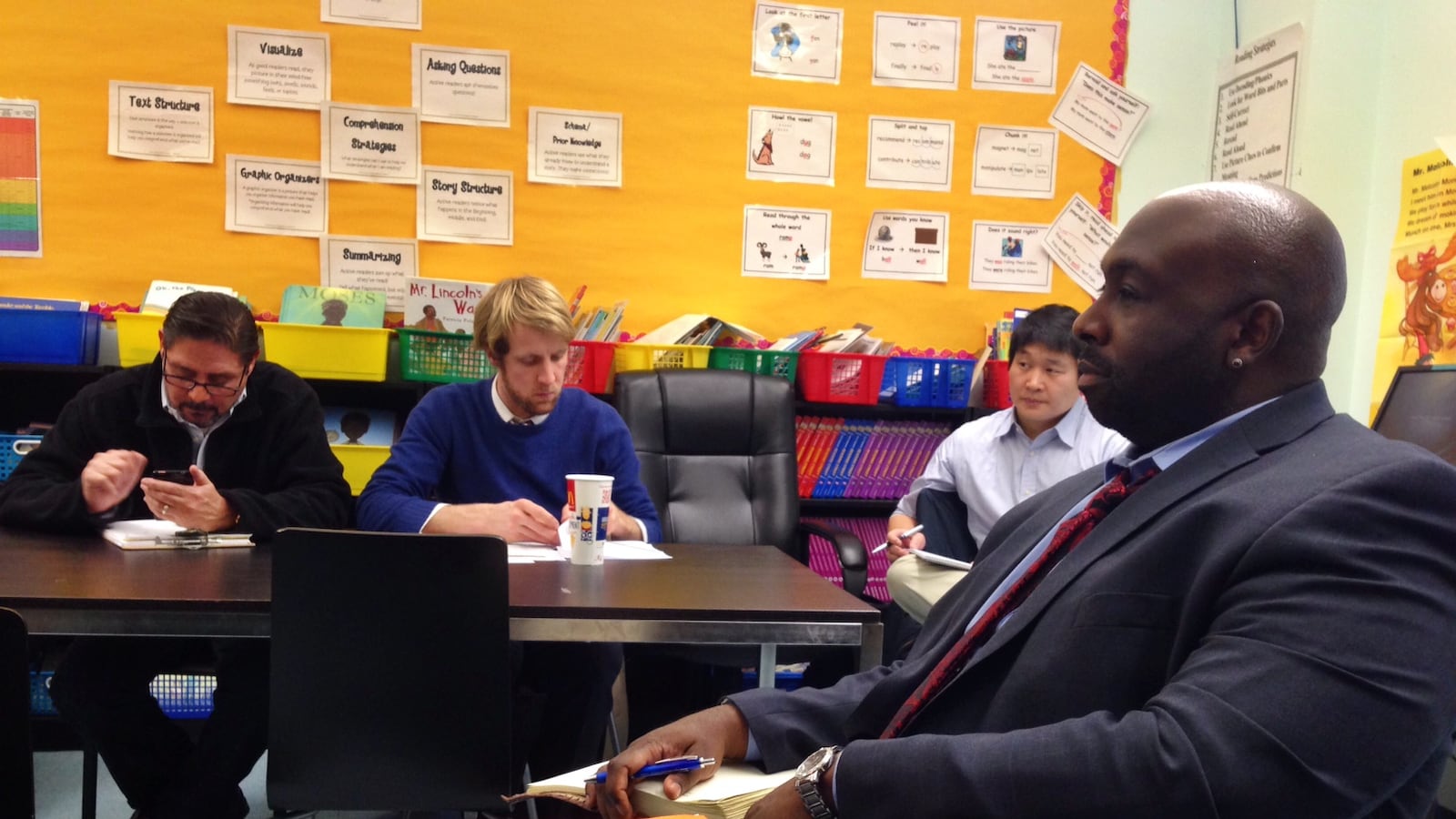 Beginning with Children elementary school principal Les King (right) discusses the school's future with board members at a committee meeting.