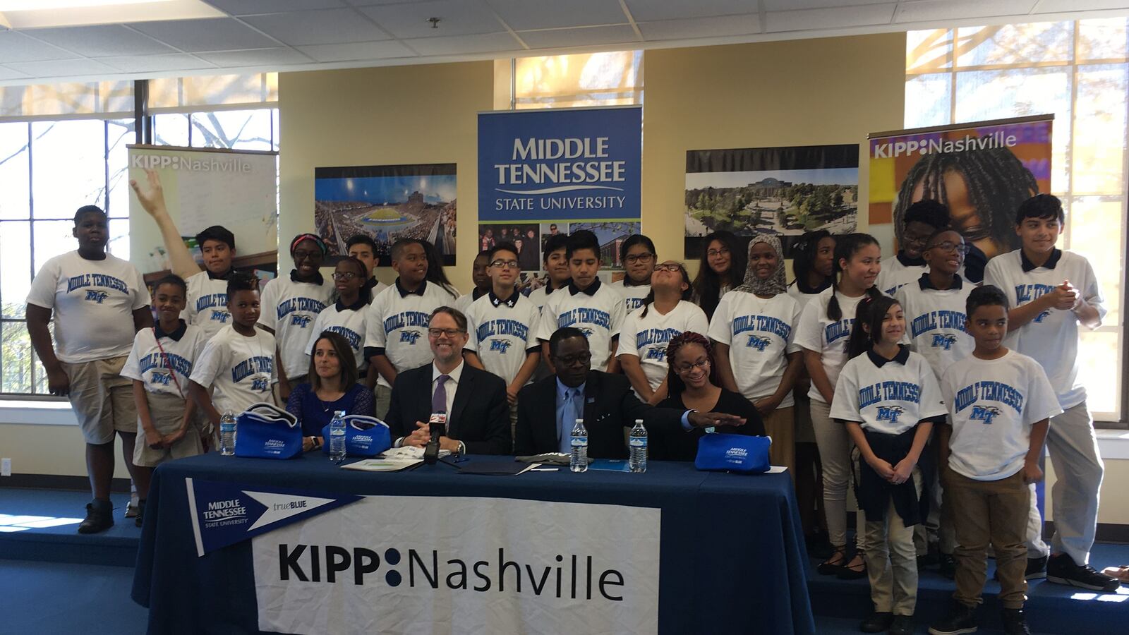 Seventh-grade students at KIPP Academy Nashville pose with (from left) School Leader Laura Miguez Howarth, KIPP Nashville Executive Director Randy Dowell, MTSU President Sidney McPhee and MTSU student Deyauna Cook.