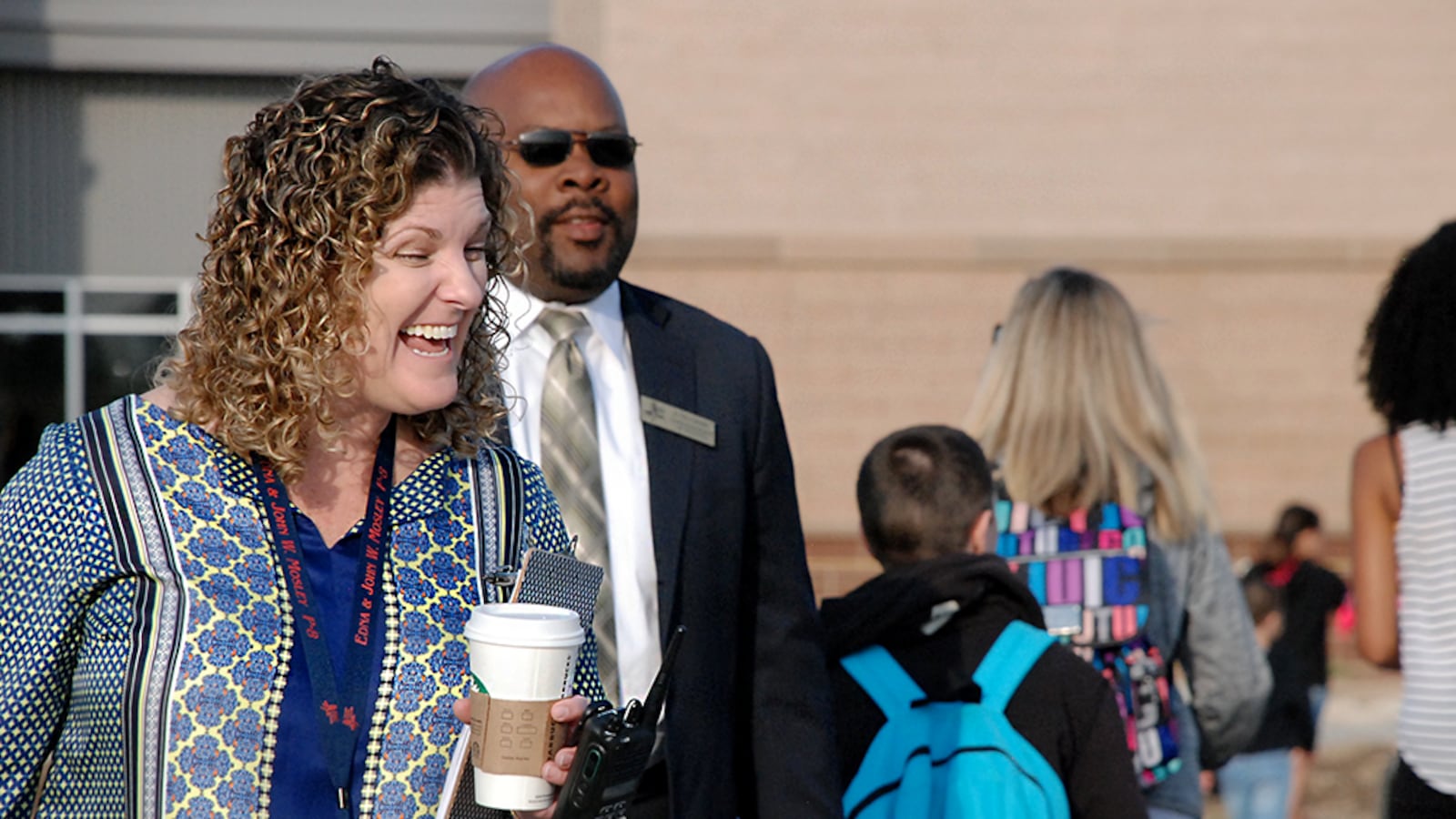 Principal Carrie Clark, left, and Superintendent Rico Munn greet students at the Edna and John W. Mosley P-8 school Monday, the first day of school for most students at the new school.
