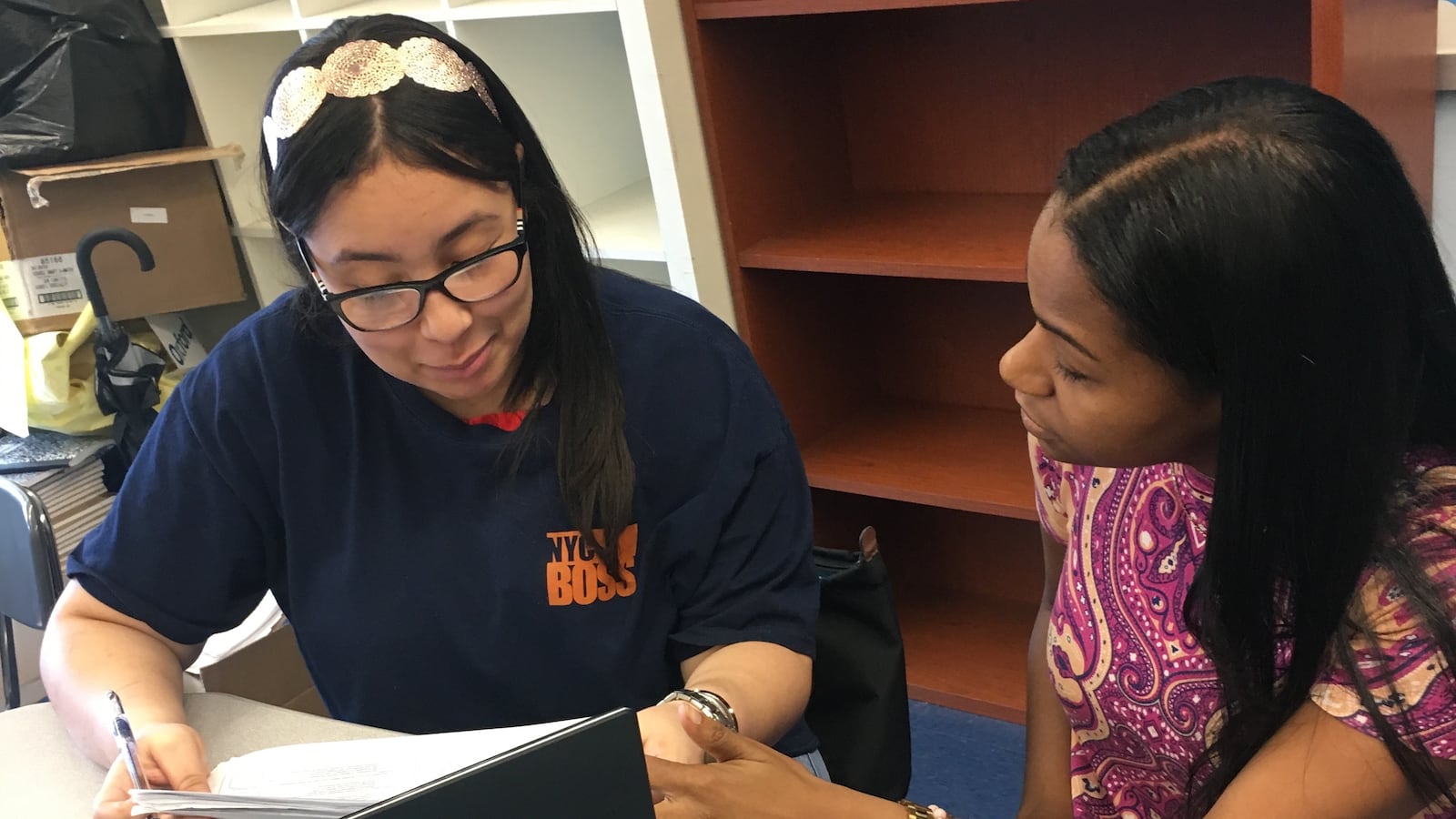 The author Jahira Chambers, right, working with a student.