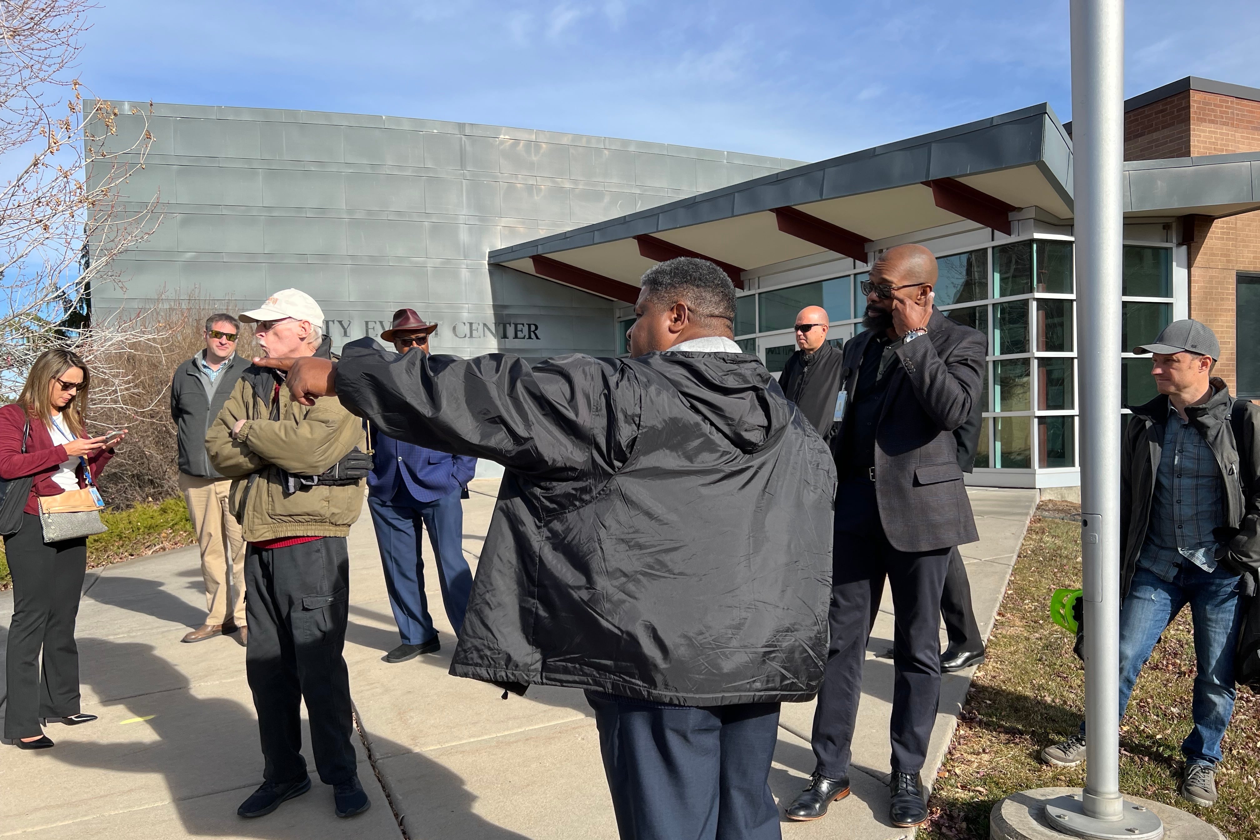A man gestures while giving a campus tour.