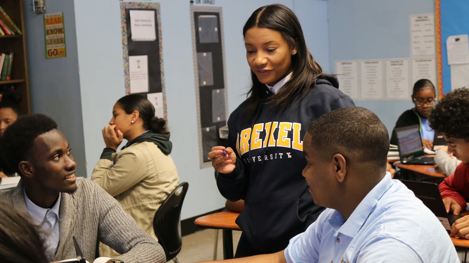 Principal Asya Johnson chats with students during an AP class.
