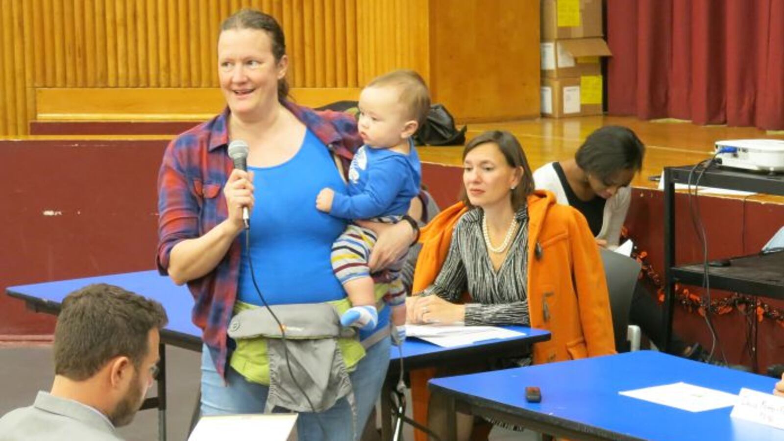 Carole-Ann Moench, a teacher at Global Neighborhood Secondary School, expresses her reluctant support for a plan to merge the school with P.S. 96. To the right is Deputy Chancellor of Operations Elizabeth Rose. ( Photo by Geoff Decker )