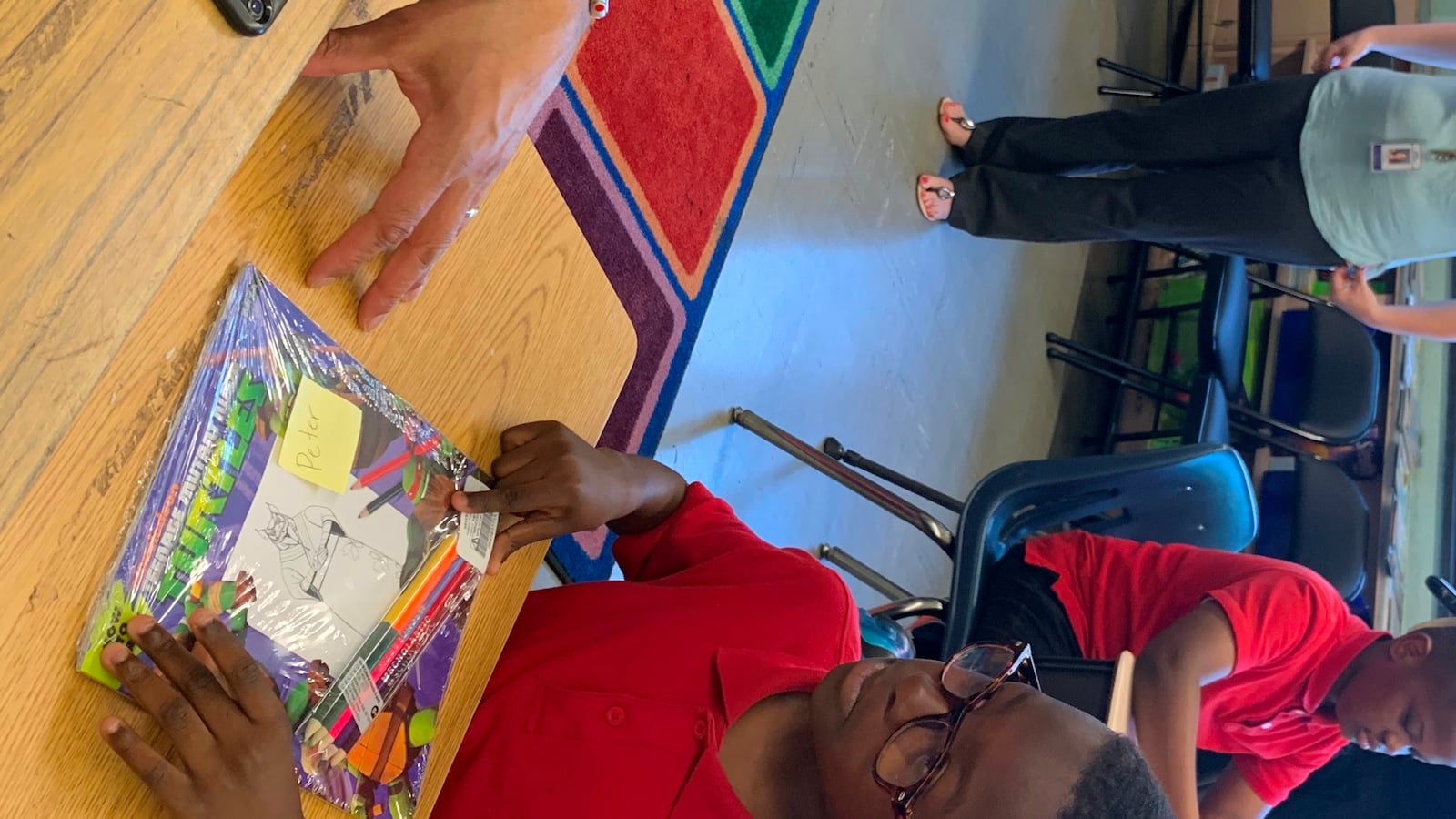 Superintendent William Hite discusses Ninja Turtles with Peter Ayodele, 8, a 3rd grader at Spruance Elementary School.