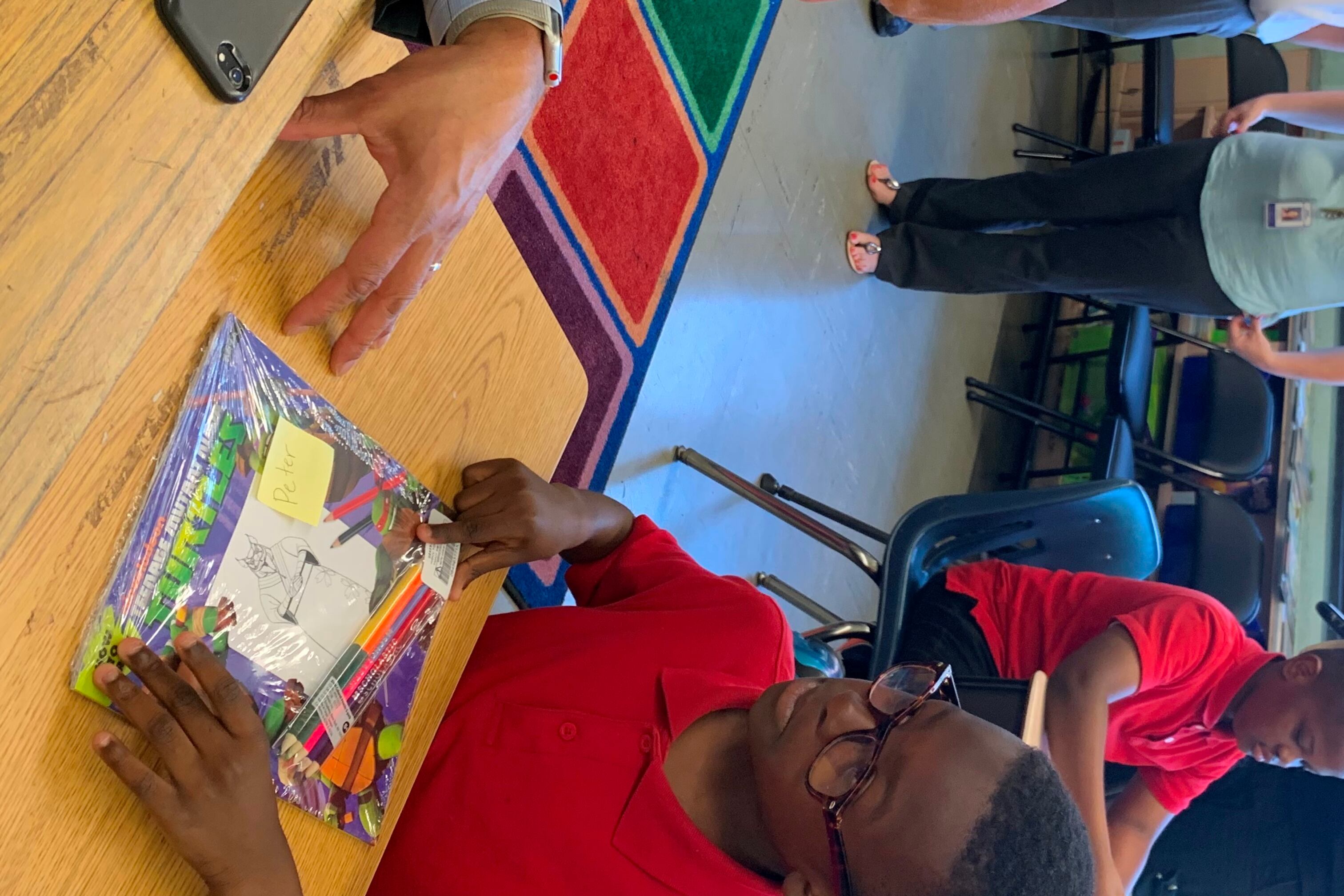 Superintendent William Hite discusses Ninja Turtles with Peter Ayodele, 8, a 3rd grader at Spruance Elementary School.