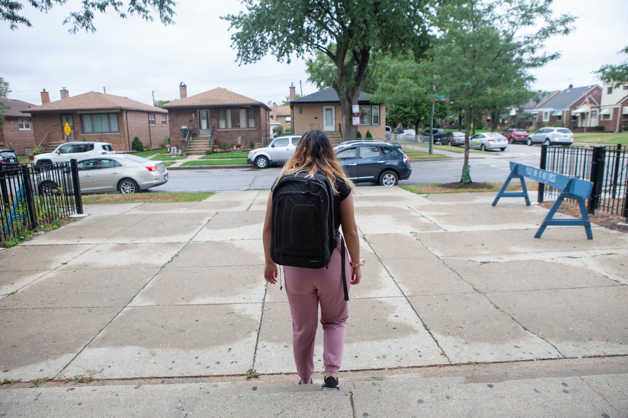 Back of a student walking down steps.