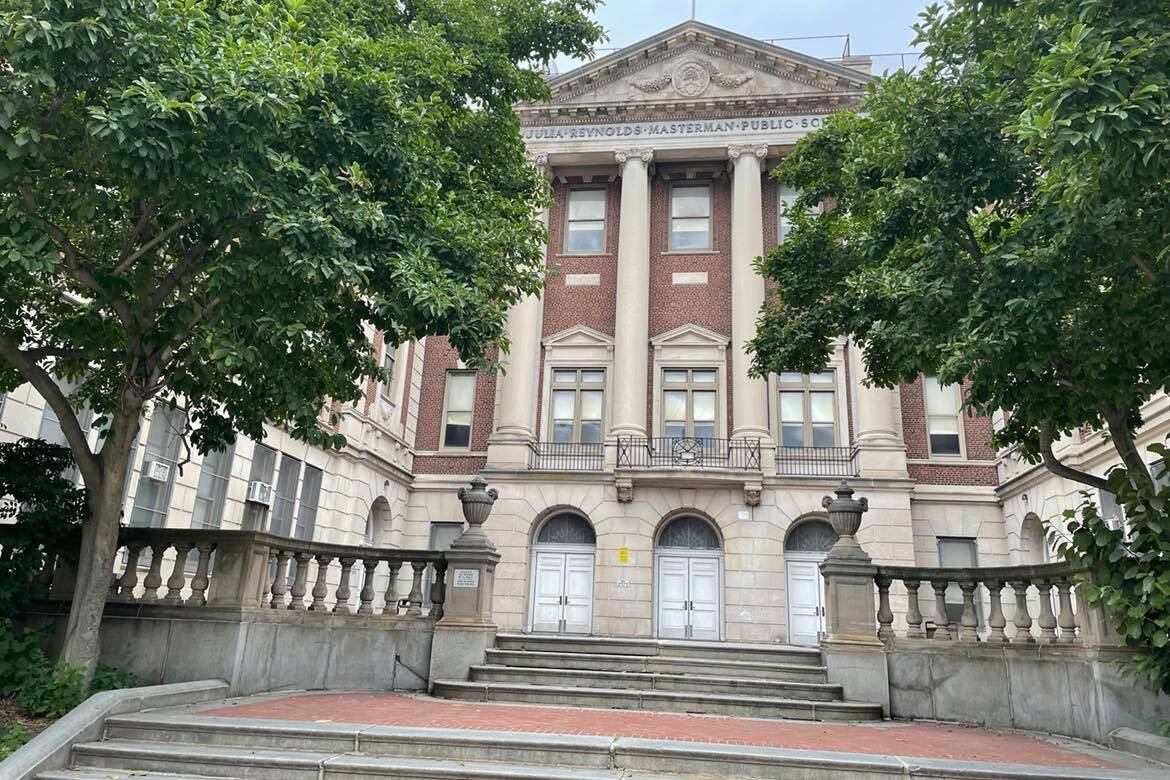 An exterior shot of Julia R. Masterman High School on Spring Garden Street, with trees in the foreground.