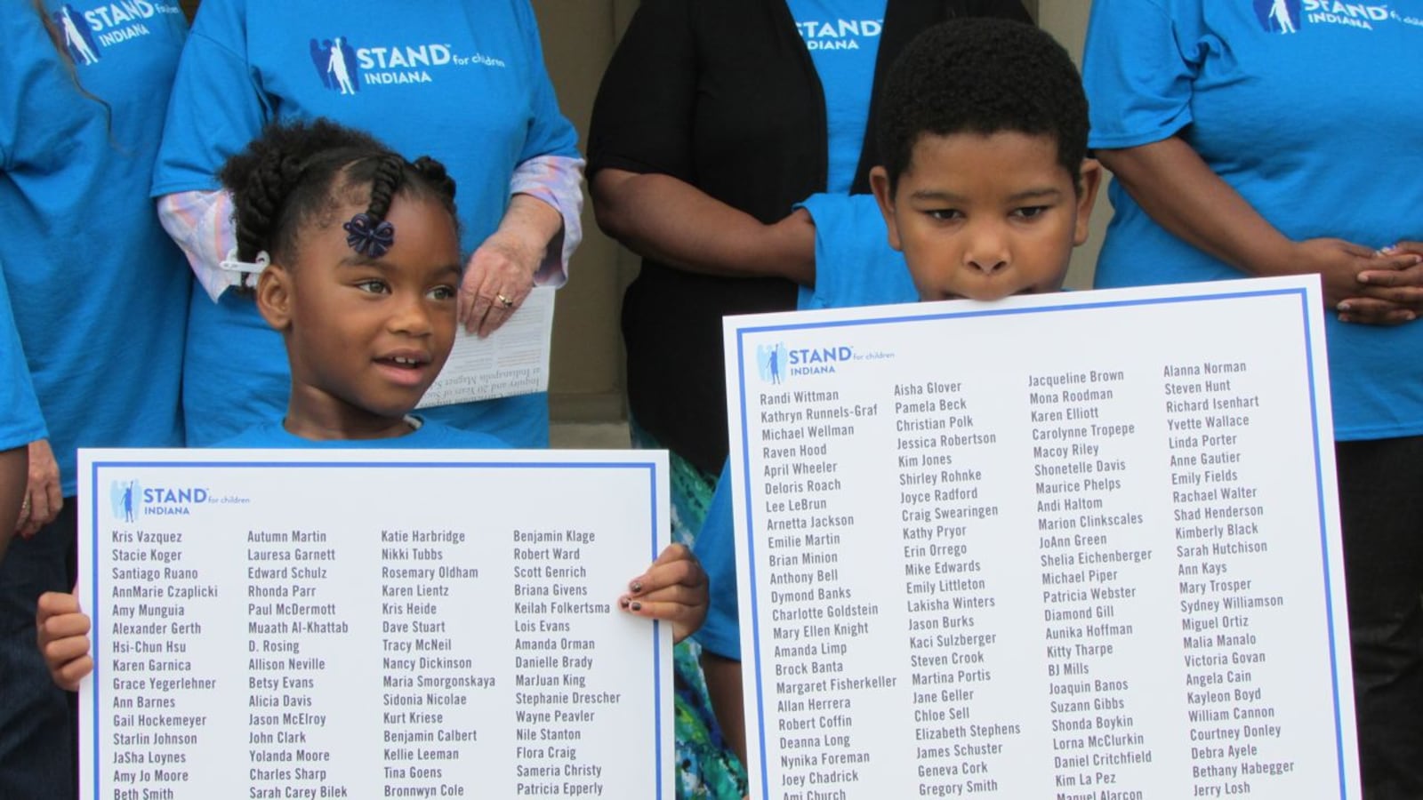 Kids hold up the names of parents who signed Stand For Children petitions supporting changes in IPS at today's press conference.