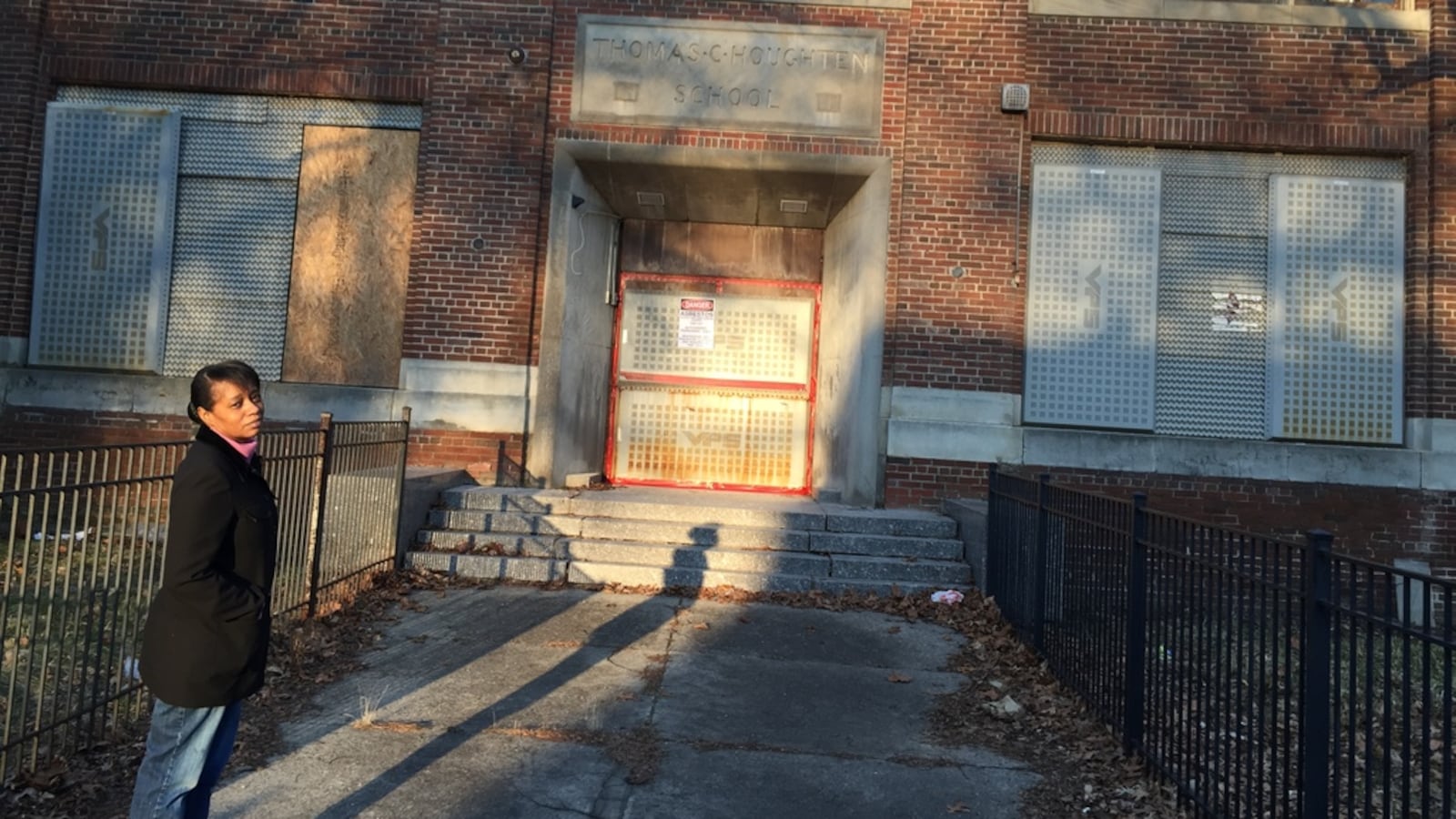 Dawn Wilson stands outside one of the many neighborhood schools in Detroit that has been shut down.