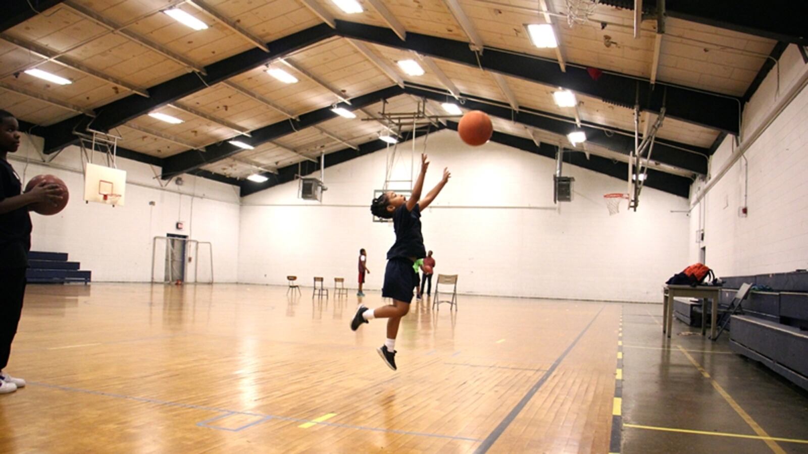 A kid shown playing in a gym in Philadelphia.