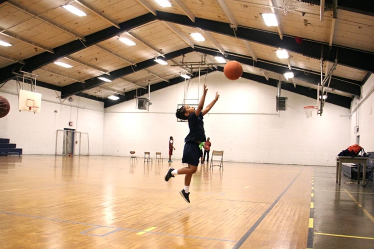 A kid shown playing in a gym in Philadelphia.