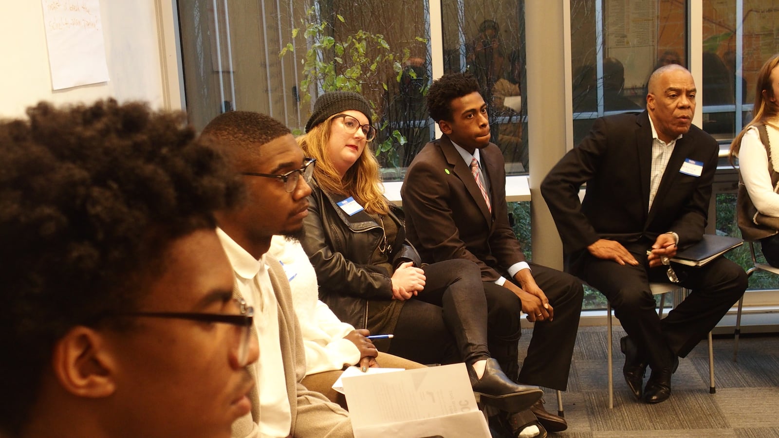Students and community members listen during a small group discussion at BRIDGES' Youth Action Networking Day on Dec. 15.