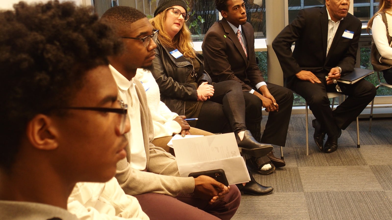 Students and community members listen during a small group discussion at BRIDGES' Youth Action Networking Day on Dec. 15.