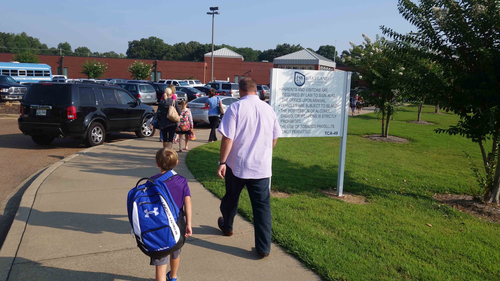 Hauling a backpack almost as big as himself, a student walks into Lakeland Elementary School on the first day of the 2014-15 school year. A resolution filed in the Tennessee General Assembly recommends that schools promote ways to avoid backpack-related injuries.