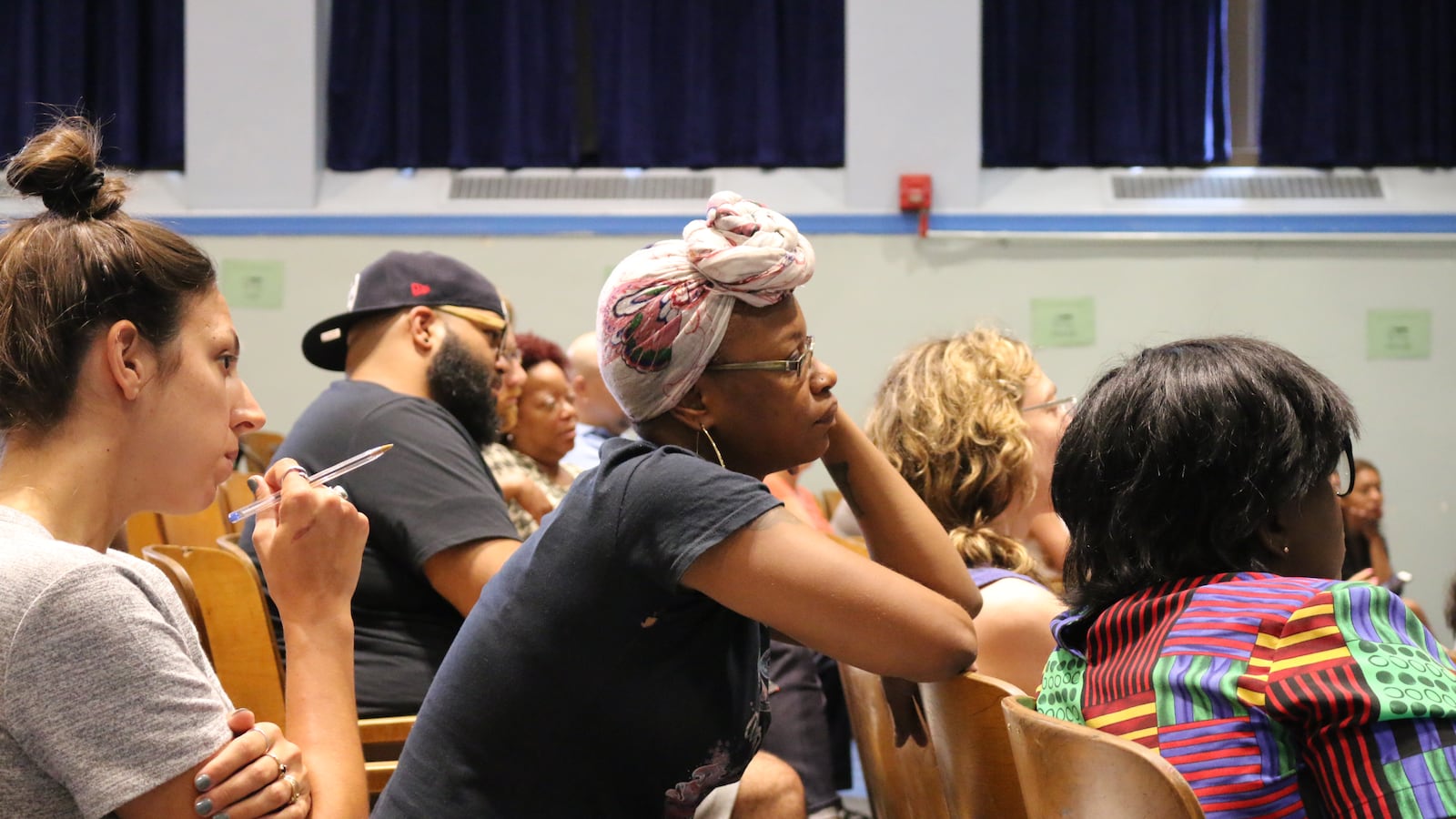 Tevina Willis, lead community organizer for the nonprofit Red Hook Initiative, listened to officials explain rezoning plans for District 15 at a meeting that was held at P.S. 676.