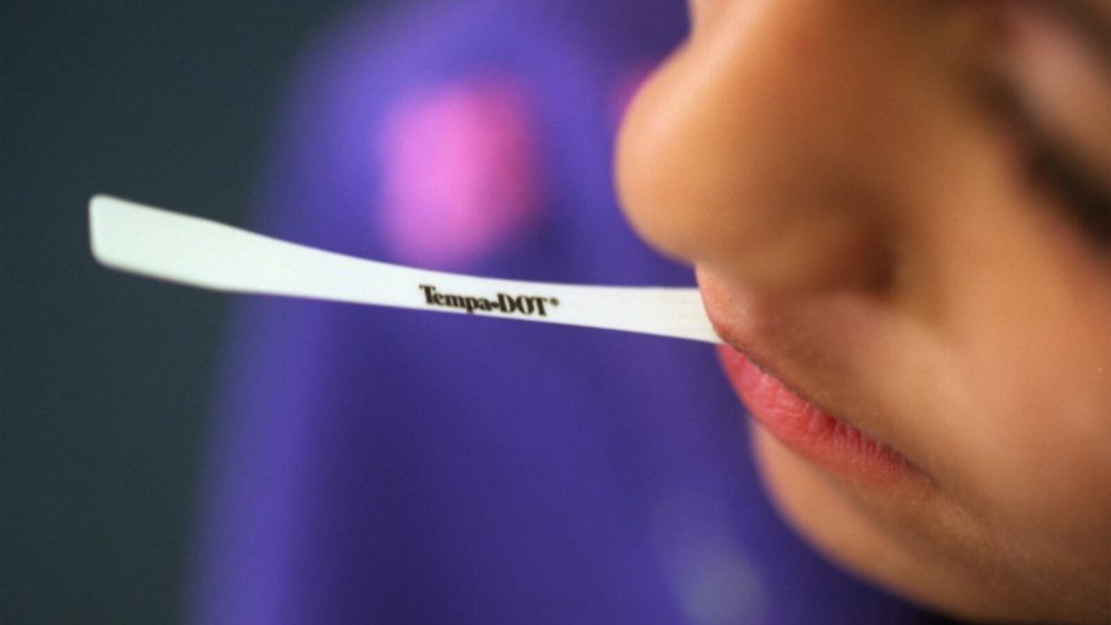 Jasmin Thind, a second-grader in California, holds a disposable thermometer between her lips in the nurse's office after feeling ill with flu symptoms.