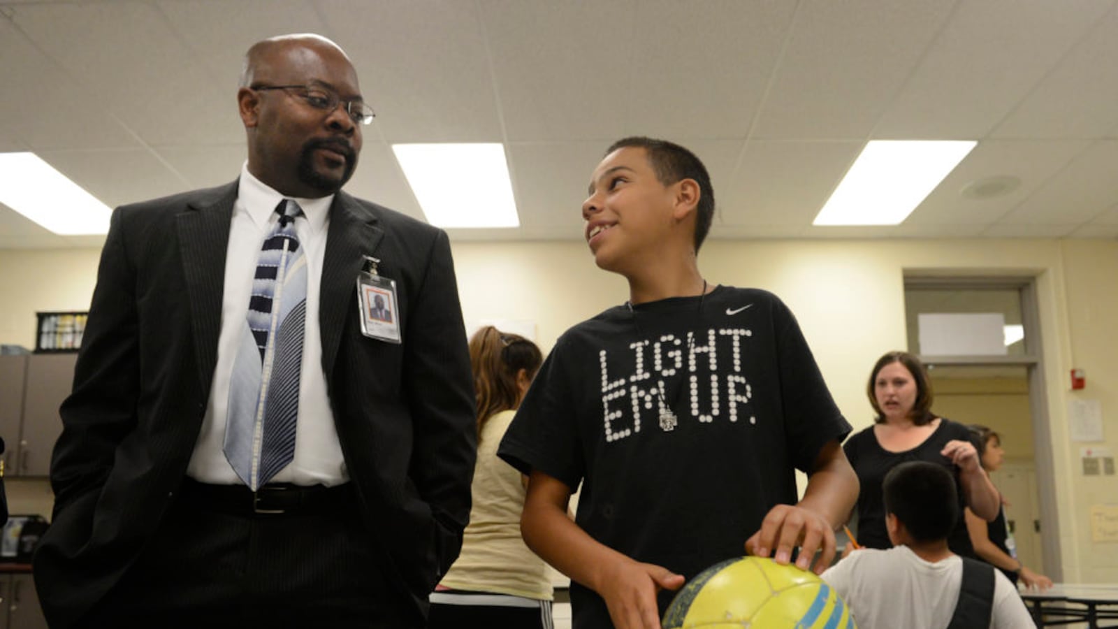 Aurora Public Schools Superintendent, Rico Munn, left, talks with a student about World Cup soccer at North Middle School in 2014.