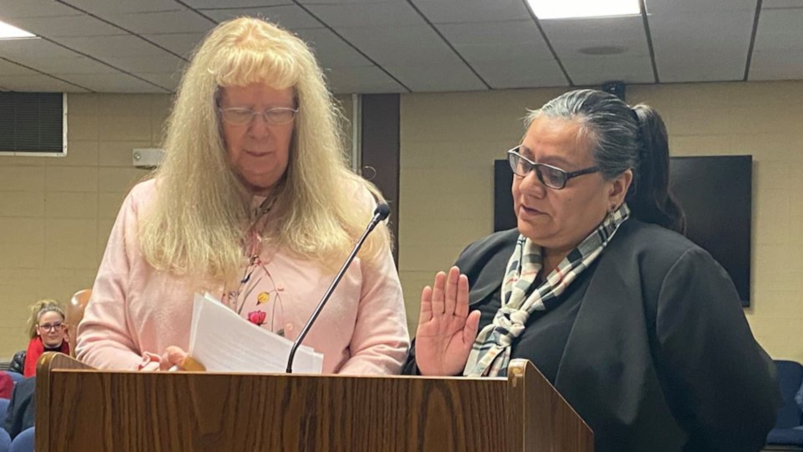 Maria Zubia, right, is sworn in as an Adams 14 school board member.