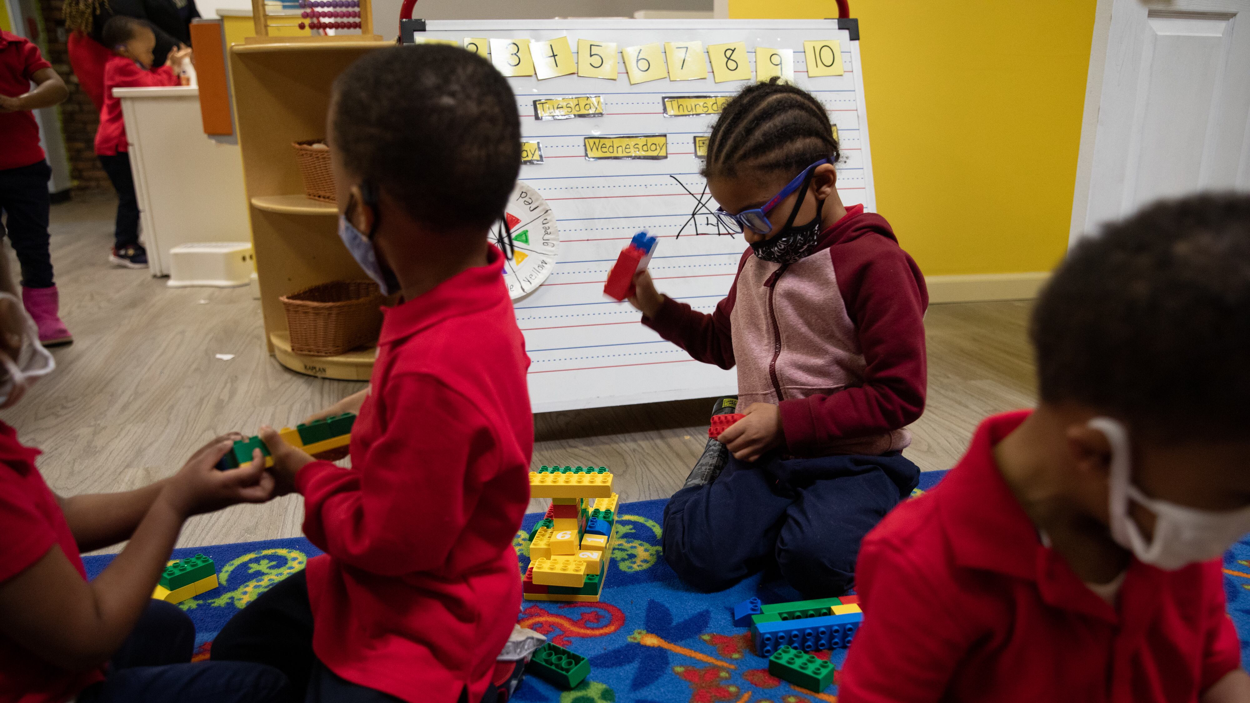 A young student plays with legos among other preschoolers at Little Scholars child care center in Detroit, Michigan, U.S., on Thursday April 1, 2021.