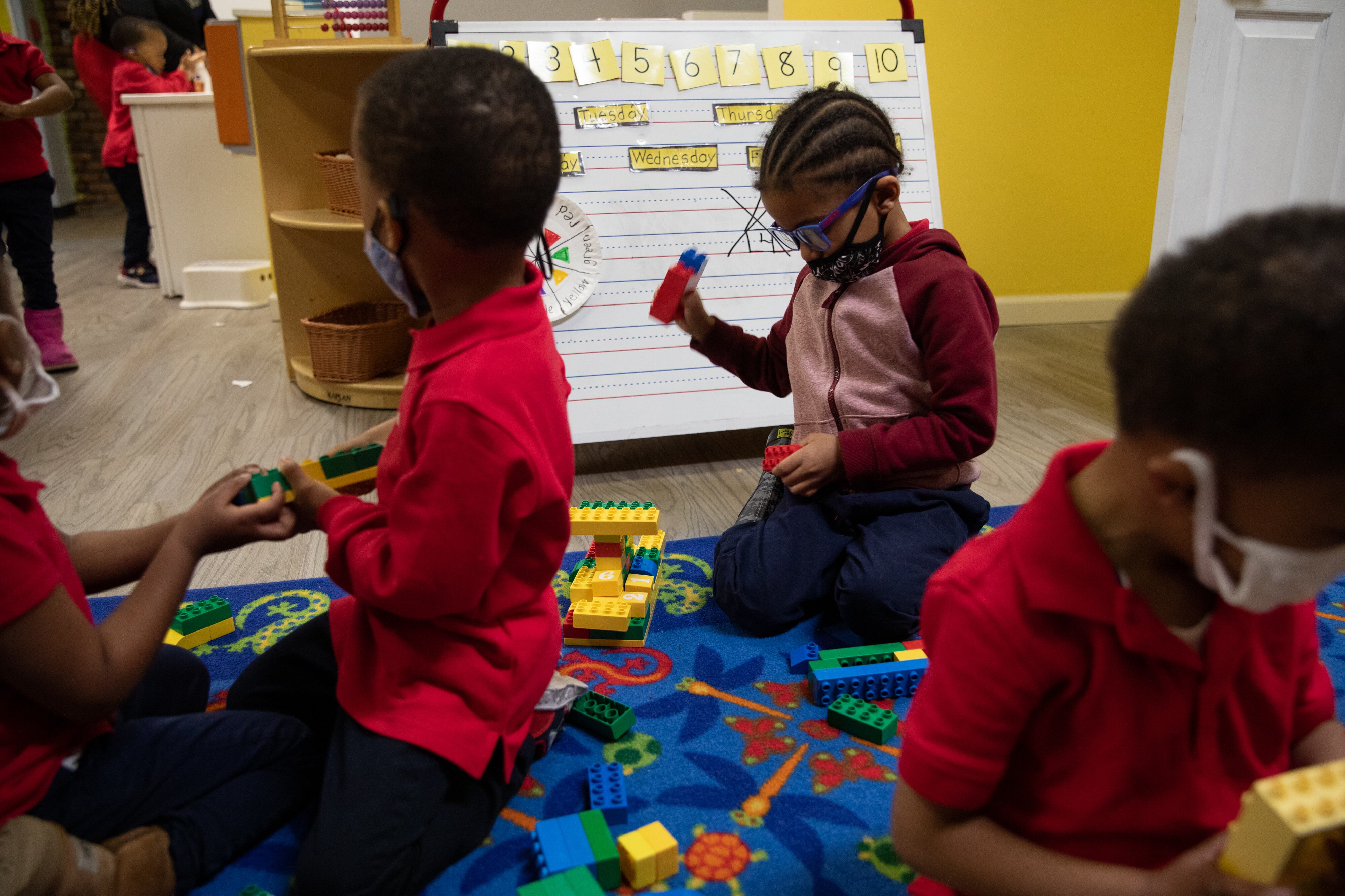 A young student plays with legos among other preschoolers at Little Scholars child care center in Detroit, Michigan, U.S., on Thursday April 1, 2021.