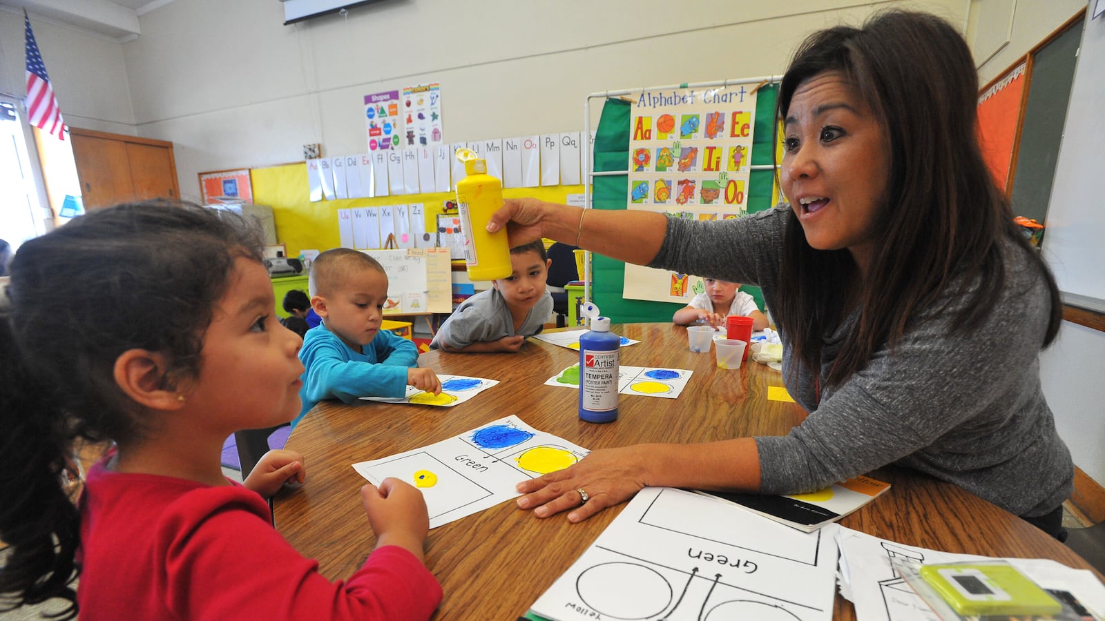 Pre-school teacher Aimee Iwasaki works with her mild to moderately disabled students including Aimee Hernandez, left, on a painting and colors exercise at Buffum Total Learning Center in Long Beach, CA on Wednesday, October 9, 2013. (Photo by Scott Varley/Digital First Media/Torrance Daily Breeze via Getty Images)