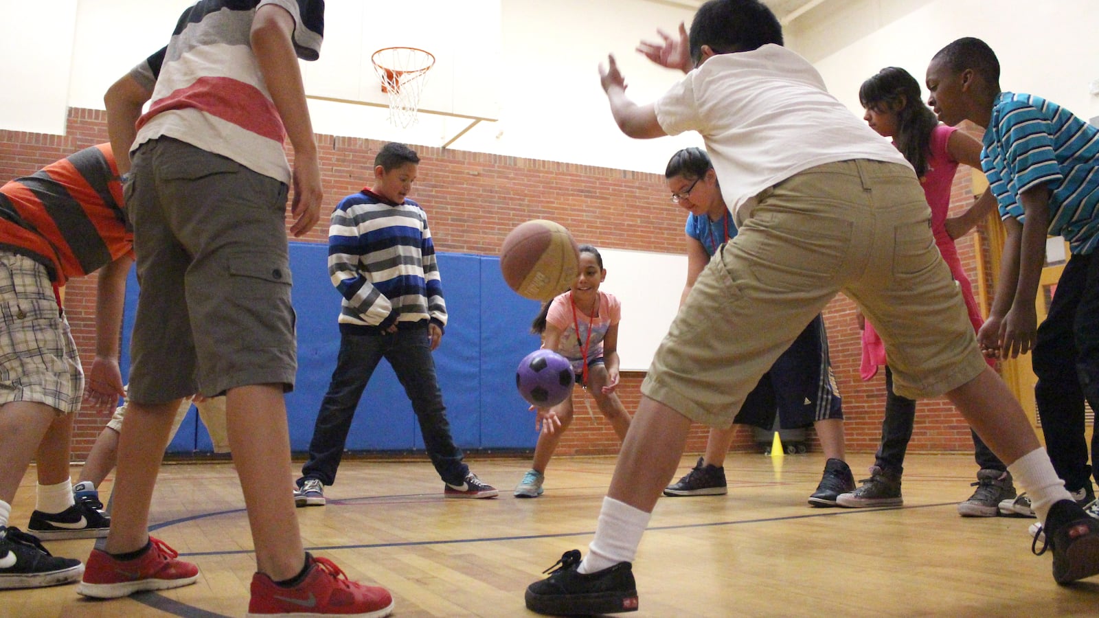 Students practiced their goalie skills by standing in a circle and trying to stop the balls from passing between their feet. This activity was offered by YMCA.