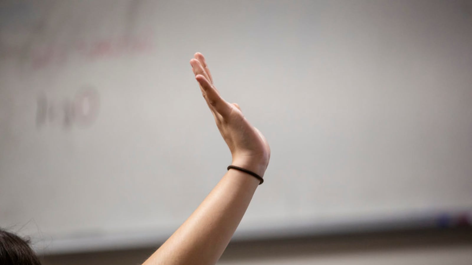 A student raises her hand.