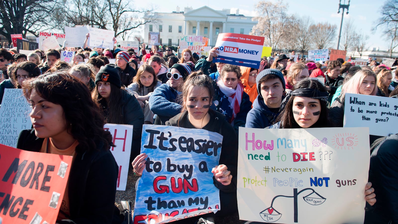 Thousands of local students sit for 17 minutes during a nationwide student walkout for gun control in front the White House on March 14, 2018. (SAUL LOEB/AFP/Getty Images)