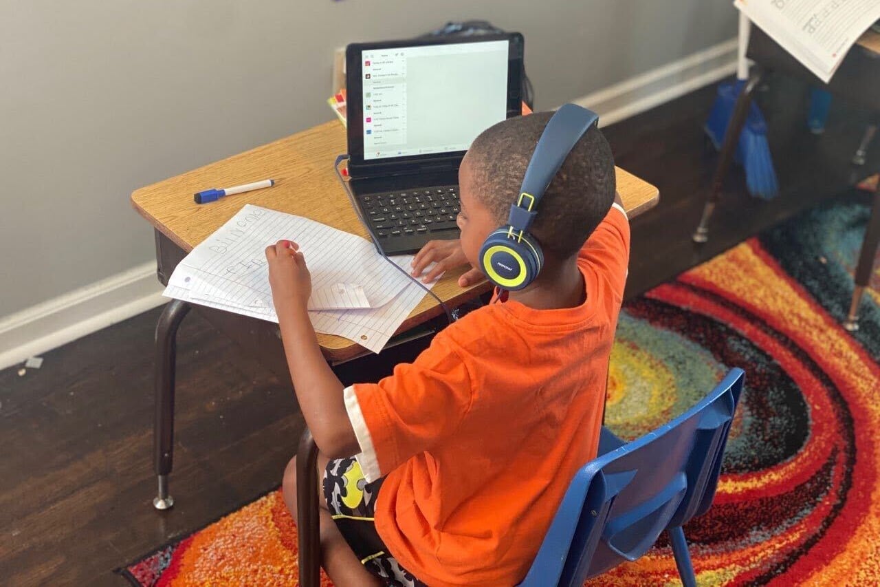 First grader Billy Onley does classwork at his desk at home as part of virtual learning in Shelby County Schools. His mother, Arionna Onley, has started a petition that requests that the virtual school day be shortened from seven hours a day.