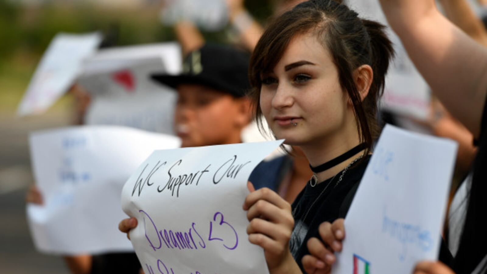Arieona Duvall-Valverde, a ninth grader at Denver's North High, holds a sign in support of the Deferred Action for Childhood Arrivals program in September 2017.