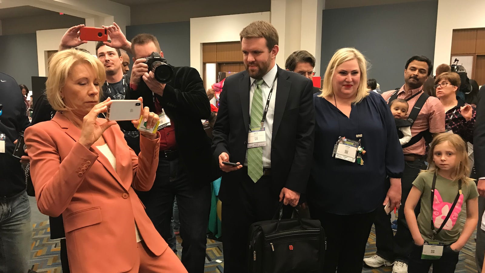 U.S. Education Secretary Betsy DeVos takes pictures on her phone during the FIRST Robotics World Championship, held in Detroit on April 27, 2018.
