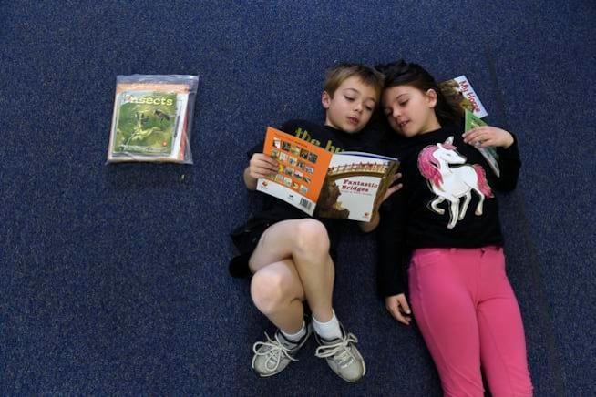Van Current, 6, left, and Natasha Williams, 7, read quietly together at Denver Green School.