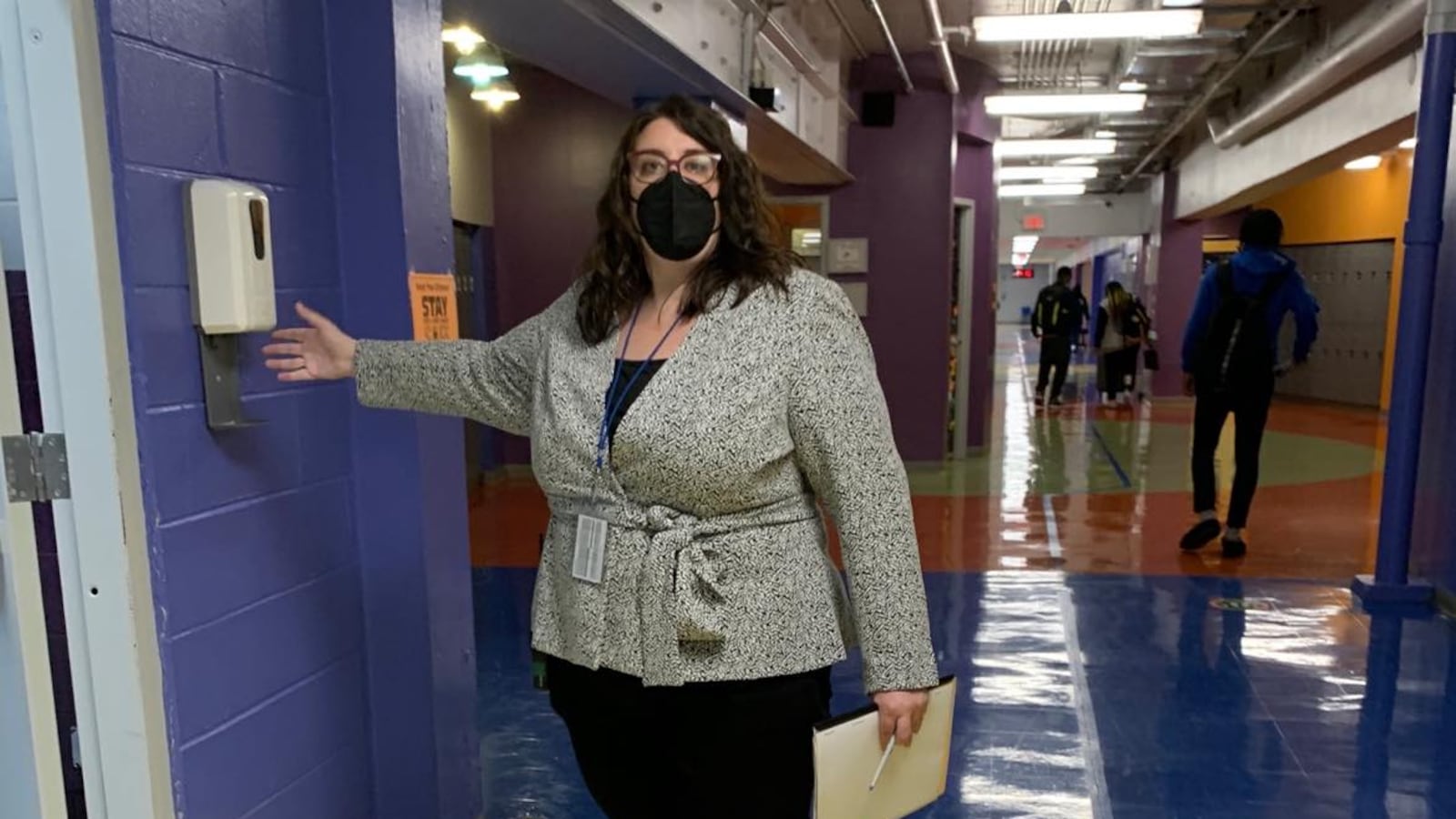 Margaux Munnelly, principal Mastery Charter School-Pickett Campus in Germantown, uses the hand sanitizer station in the hallway.