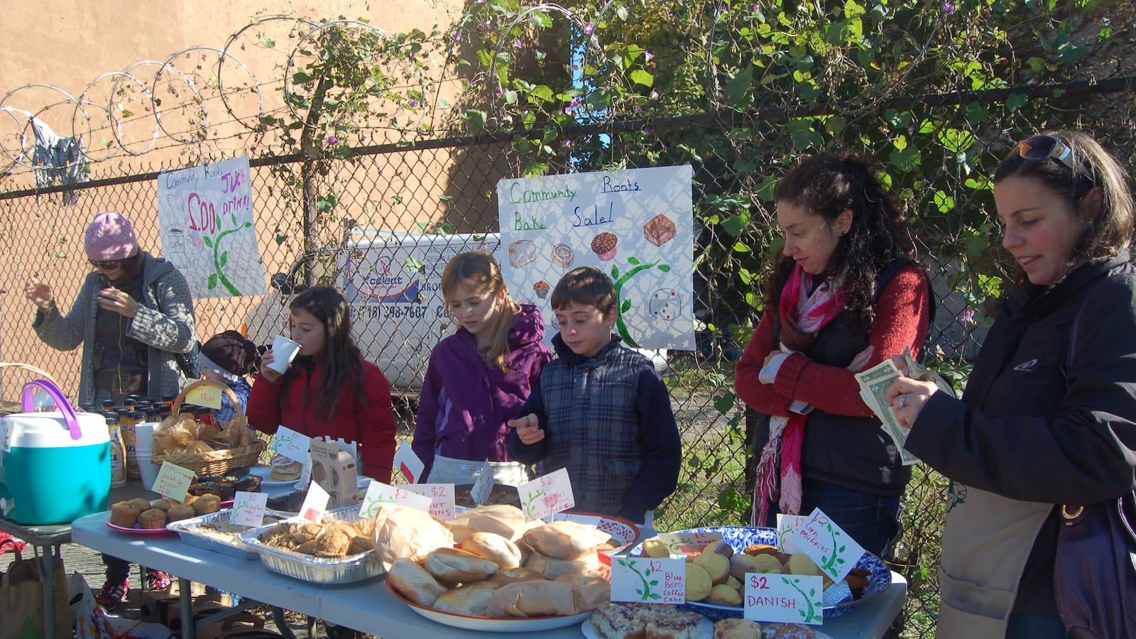 Families from Community Roots Charter School in Brooklyn hold a bake sale.