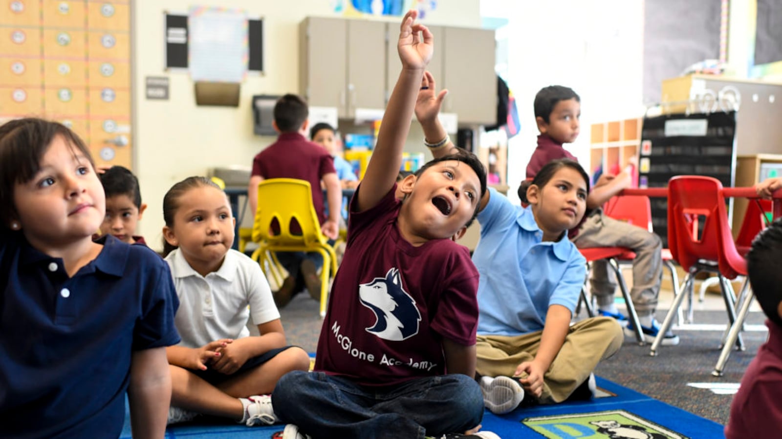 Ismael Mora raises his hand on the first day of school at McGlone Academy in Denver on Aug. 15, 2018.