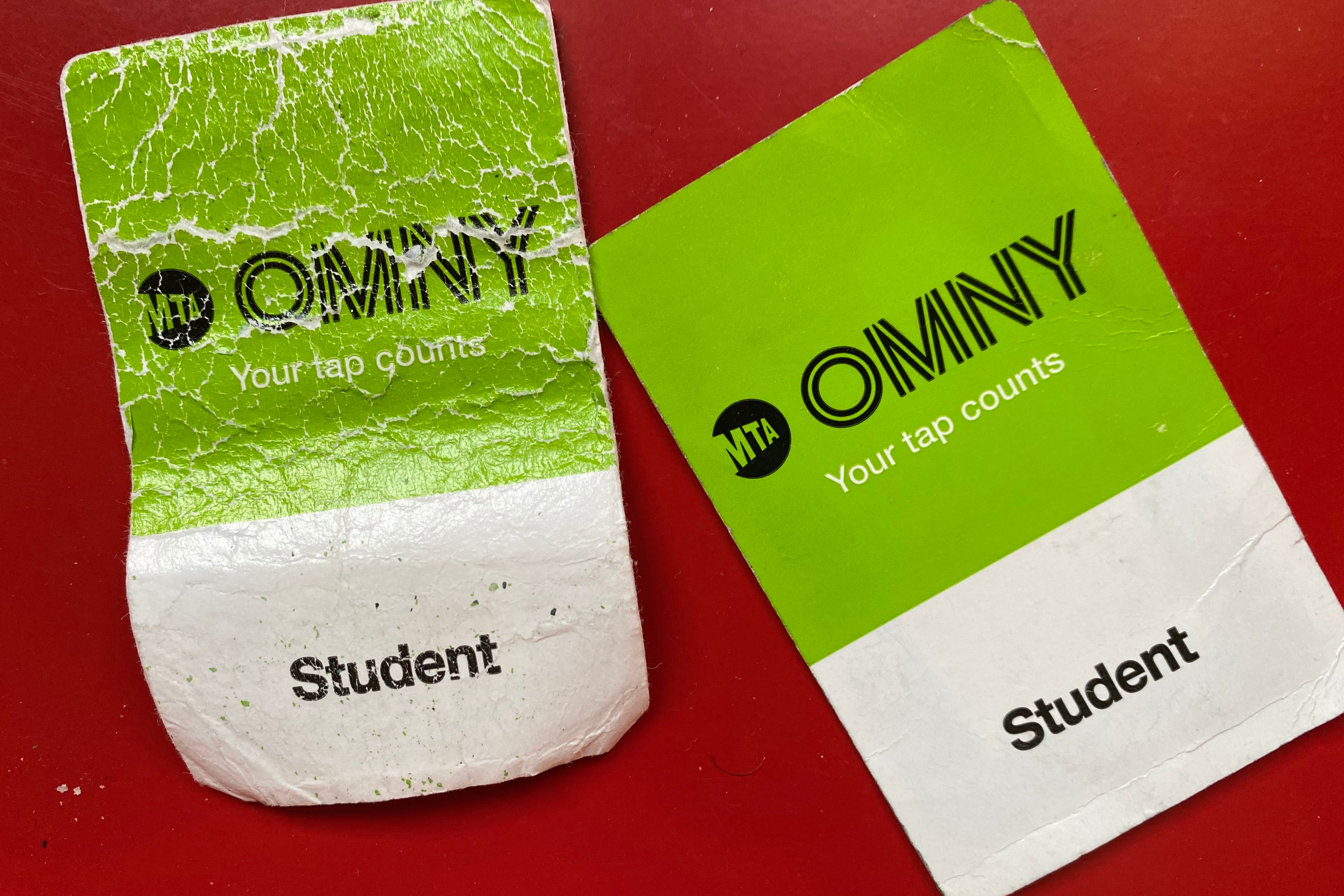 Two white and green cards on a red background.