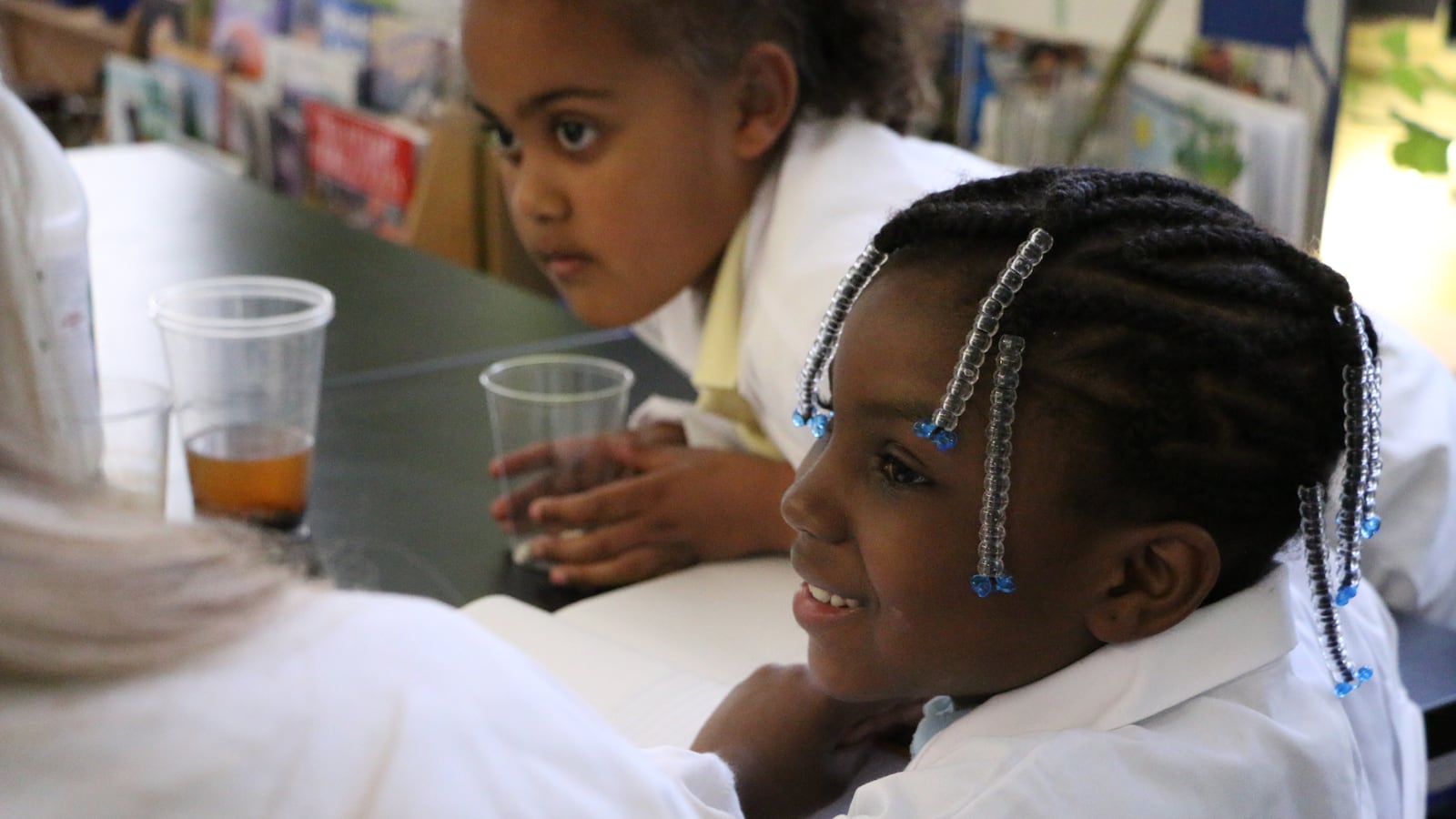 A second-grade student at P.S. 307 in Brooklyn does a STEM-focused experiment manipulating water in class.