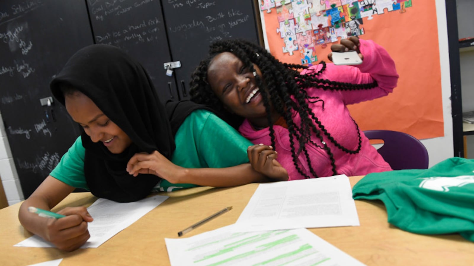 Mary Getachew, 15, right, laughs with her peer mentor Sabrin Mohamed, 18, left, at Denver's North High School in 2016.
