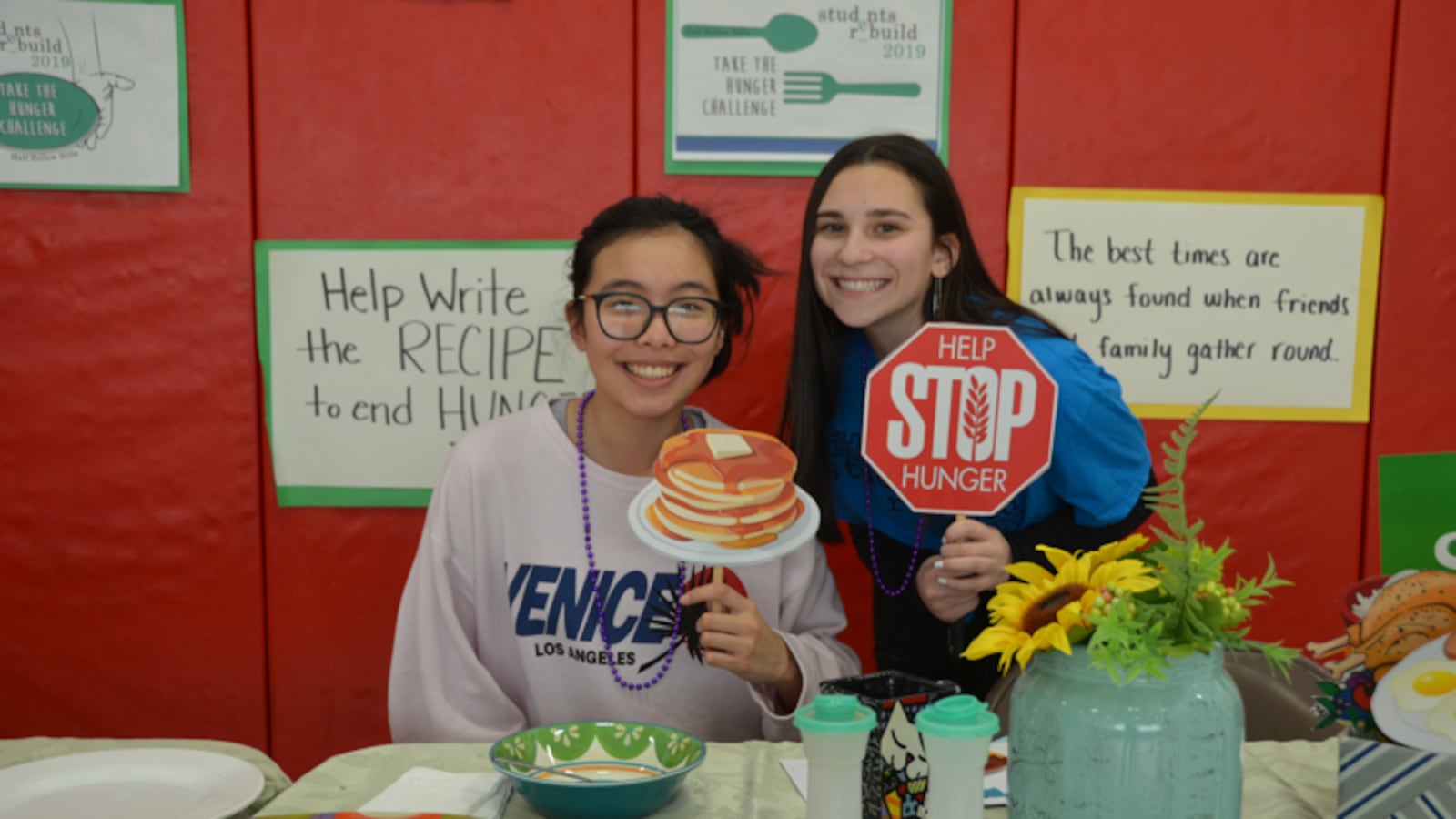 Two students pose at a school event to raise awareness about hunger