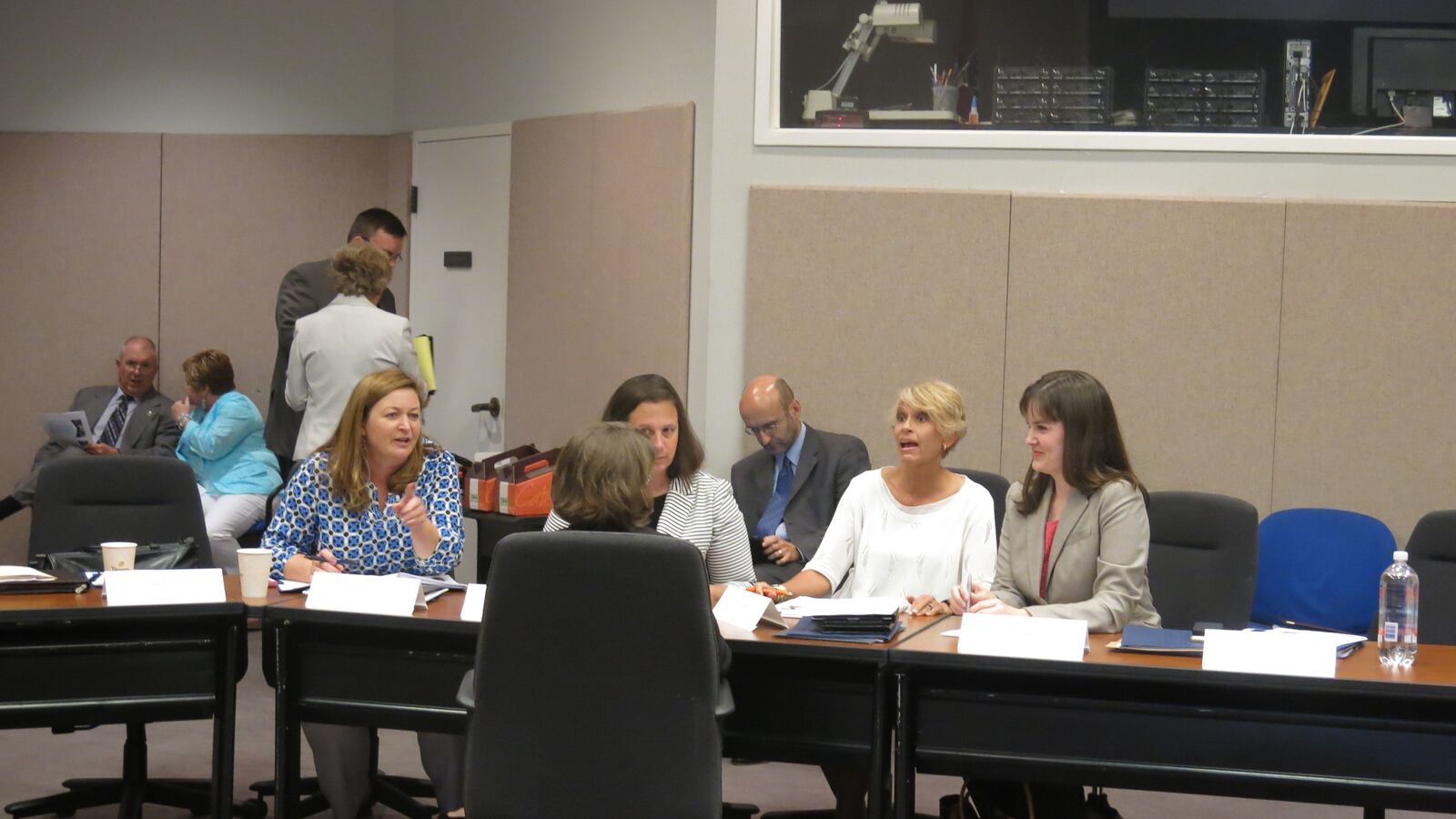 Education Commissioner Candice McQueen (right) discusses assessments during a task force meeting.