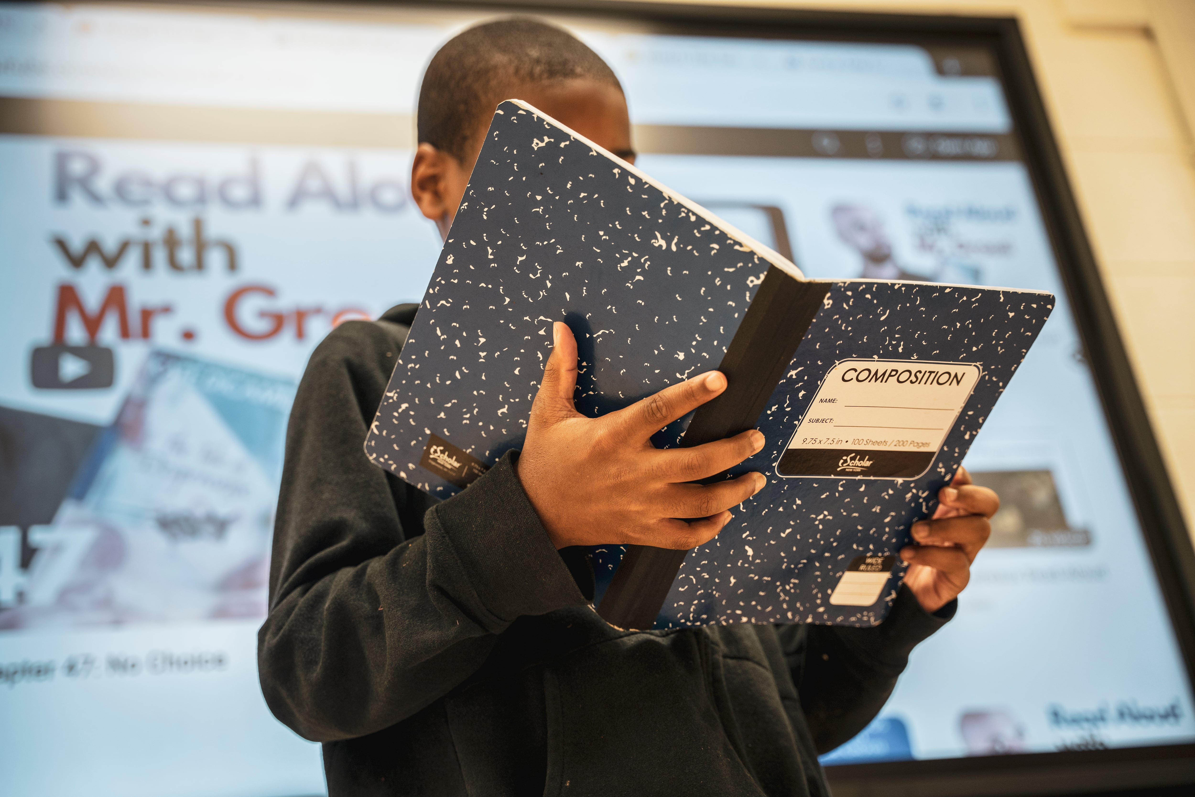 A male student holds a book.