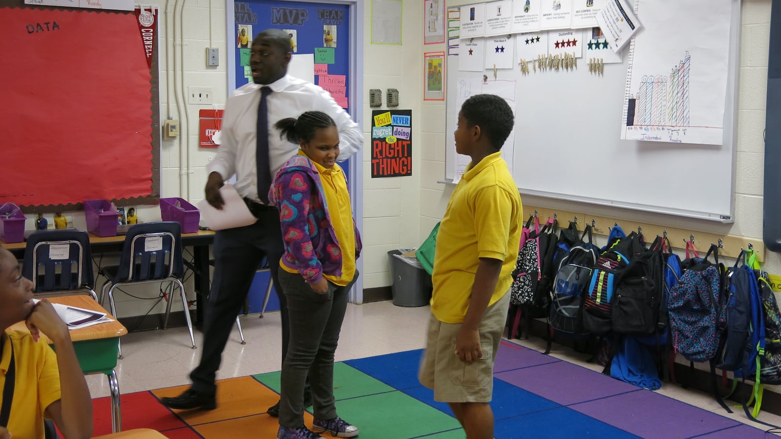 Aspire teacher Ayo Akinmoladun picks two students to act out a scene from "Growing Pains."