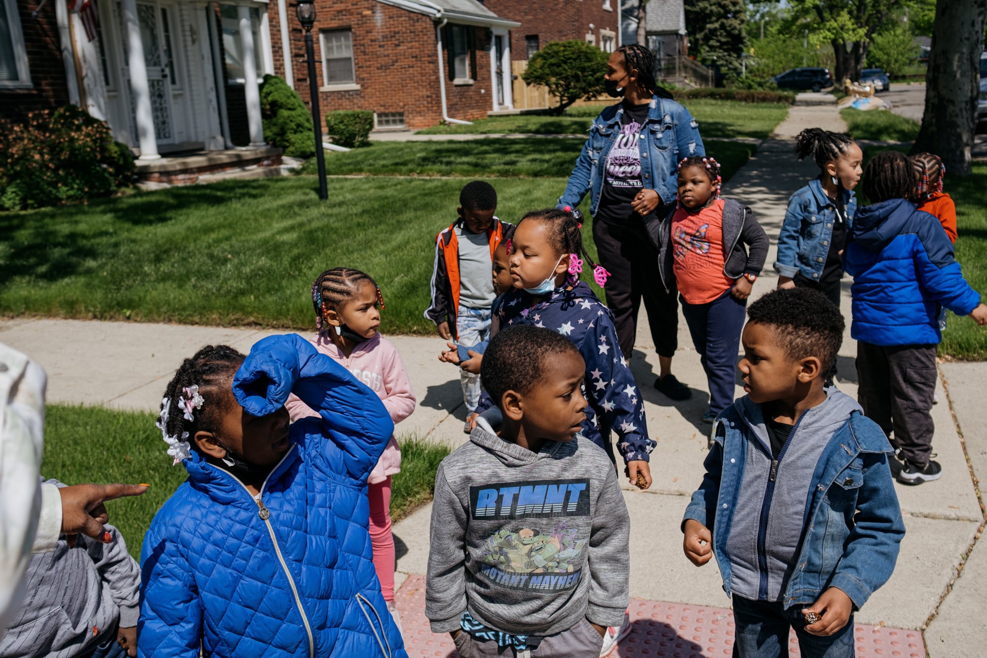 A group of children in a preschool program take a walk outside.