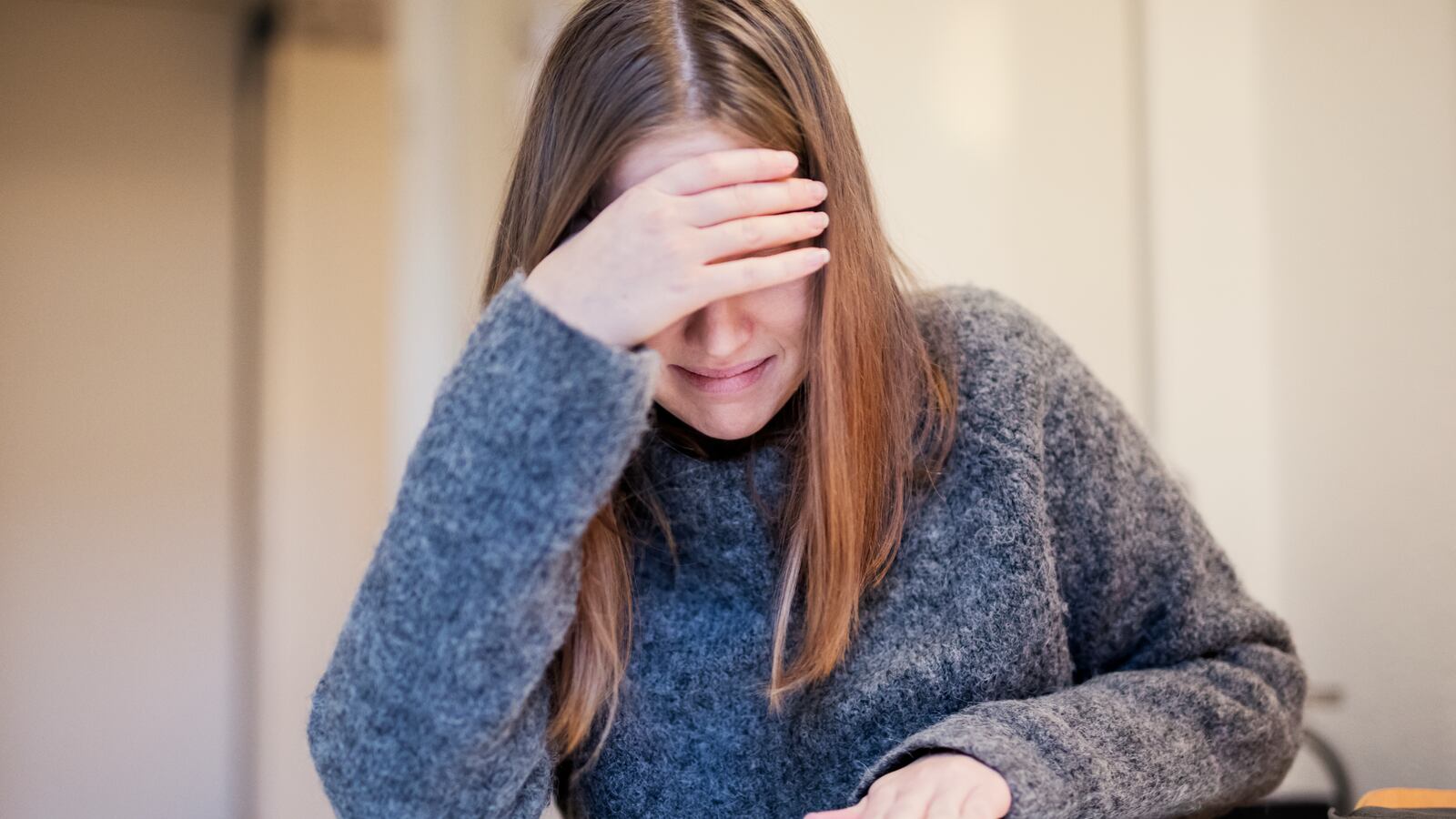 Distraught woman in a gray sweater