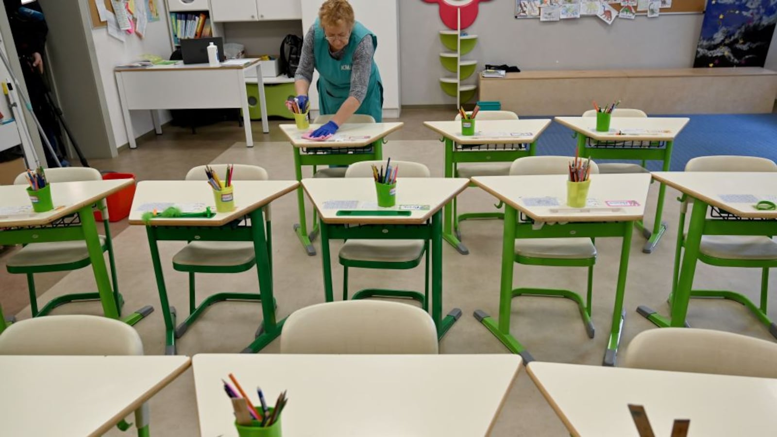 An employee disinfects a classroom of a school in the Ukrainian capital of Kiev on March 12, 2020. - Ukrainian authorities announced on March 11 they were closing schools and universities across the country for three weeks to prevent the spread of the novel coronavirus.