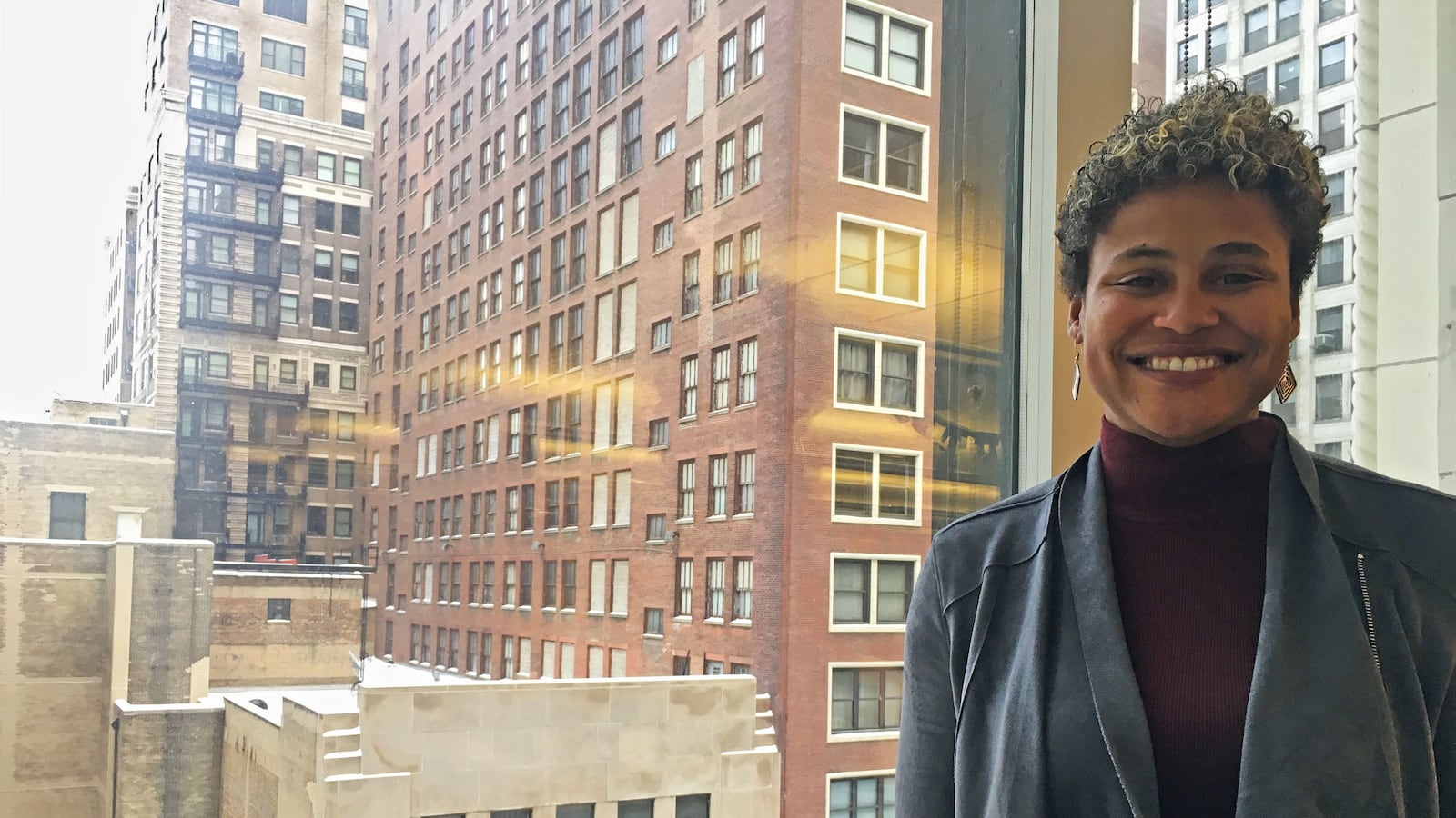 Noble CEO Constance Jones stands in front of a window at the network's downtown office.