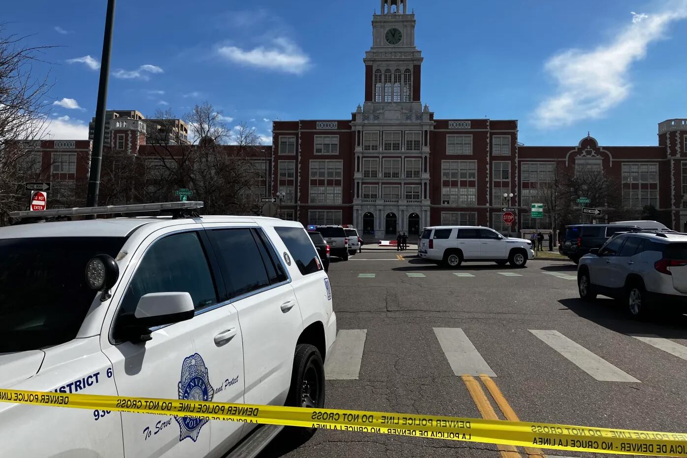 A police car sits outside East High School in Denver.
