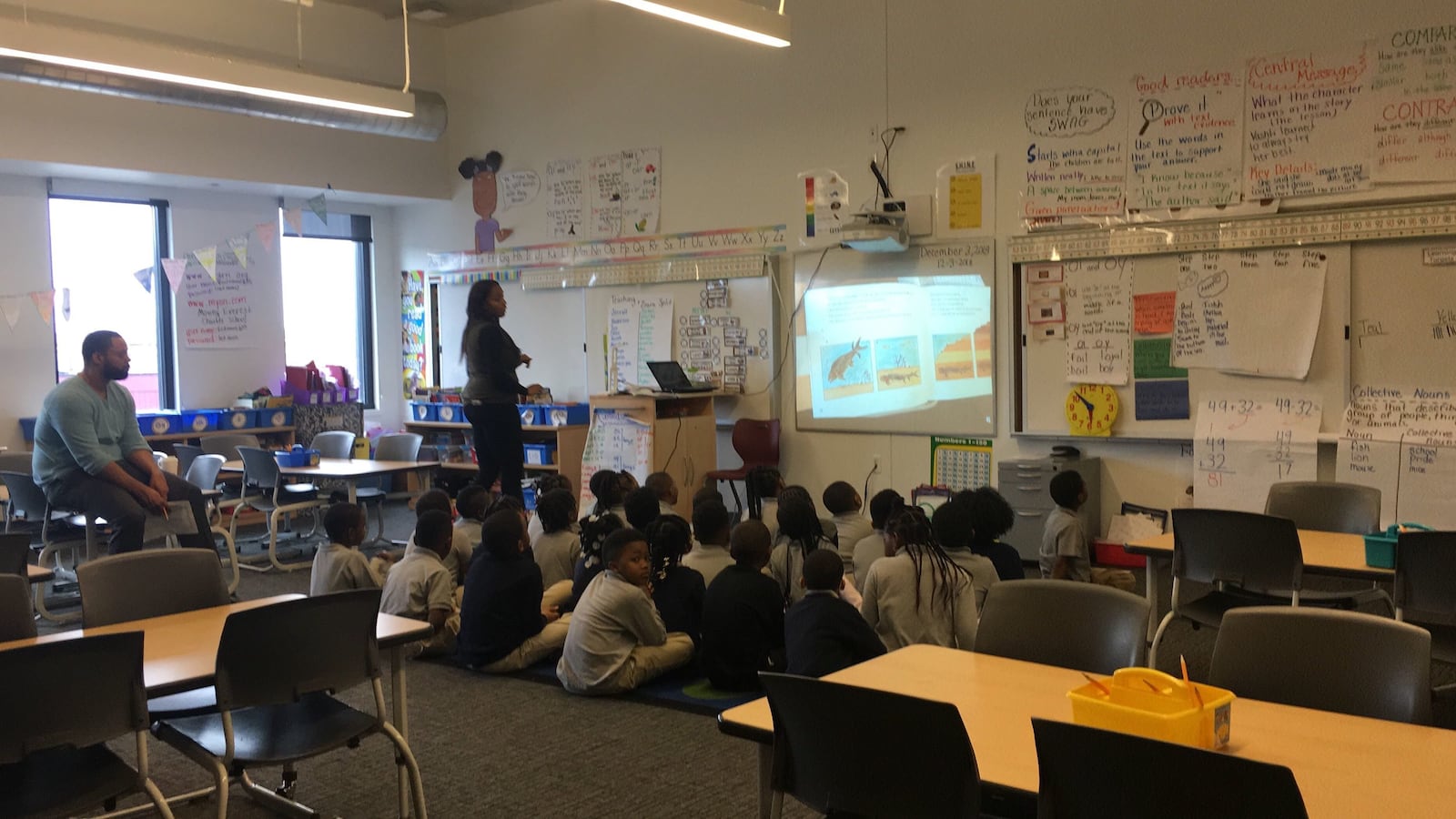 Elementary students at Moving Everest charter school read about fossils.