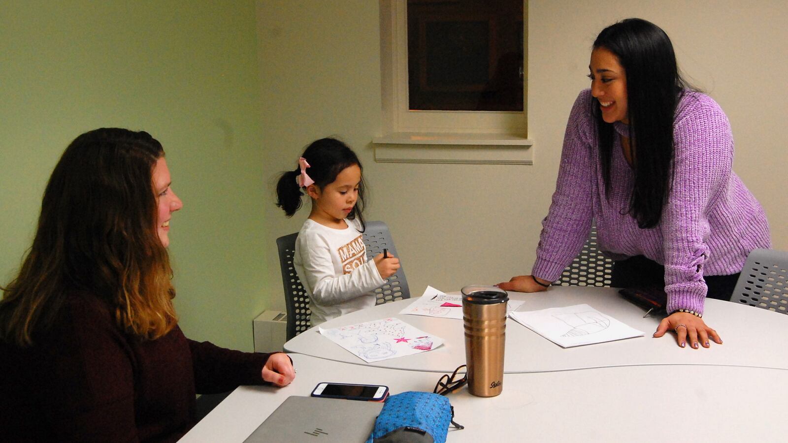 In December, Afrodita Salgado (right) brought her 5-year-old daughter, Amelia, to meet with her coach, Angela Crawford Neven, in a Chicago public library as part of a new online college program.